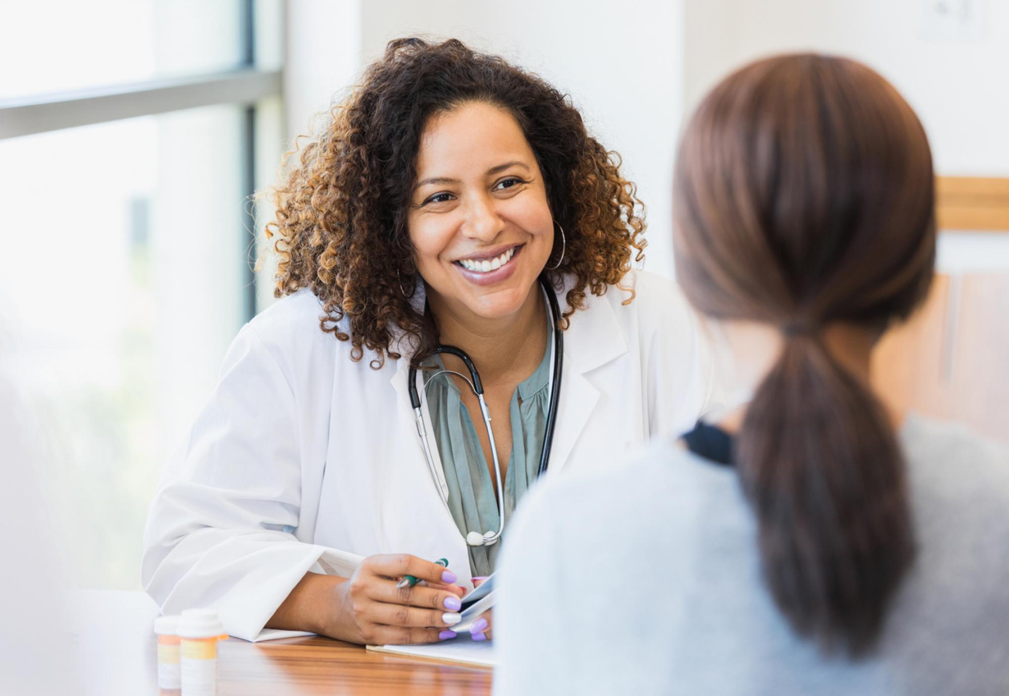 Image of a female doctor with a patient depicting NHS Scotland's new menopause and menstrual health policy