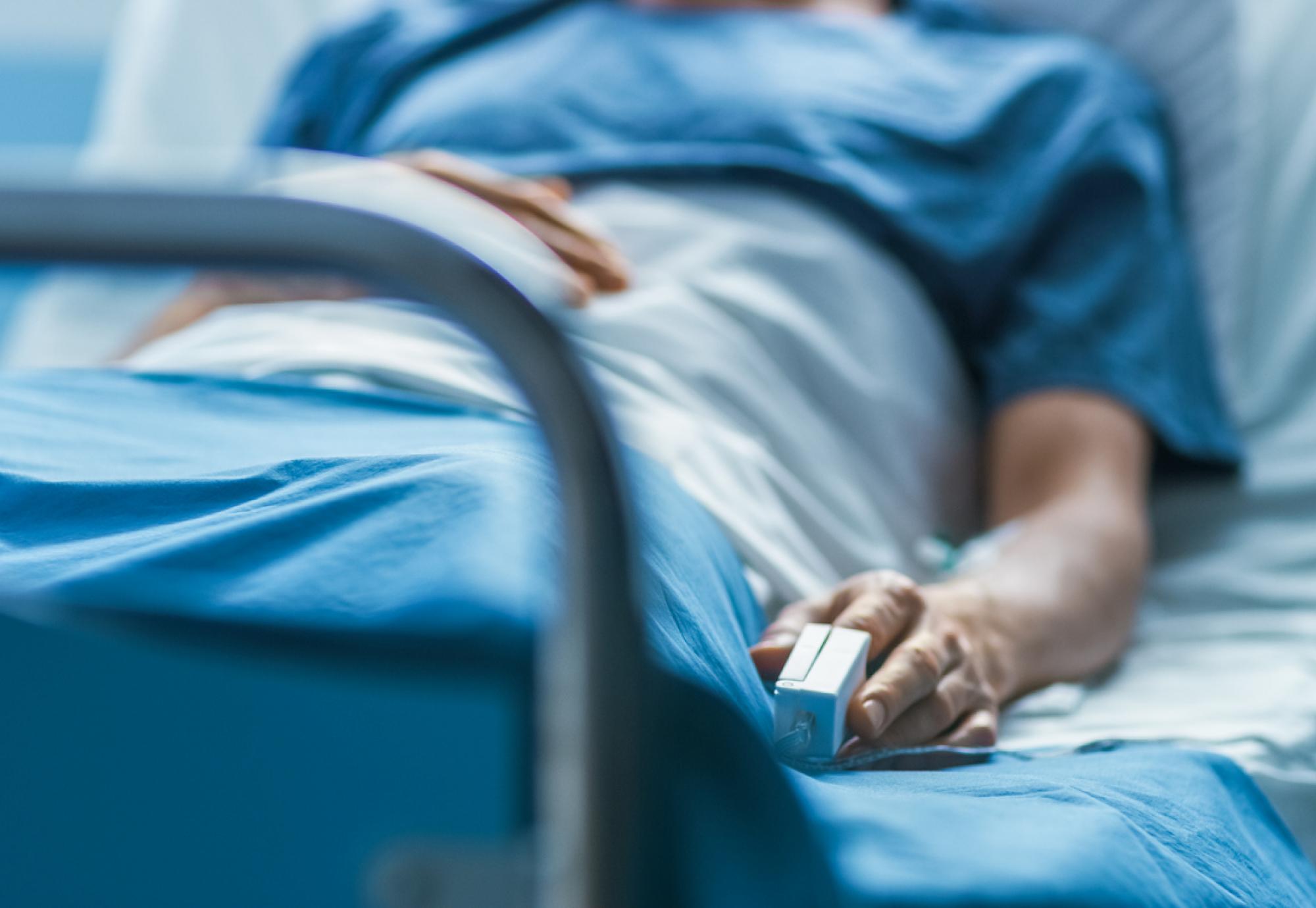 Image of a patient in a hospital bed depicting NHS cancer diagnostics