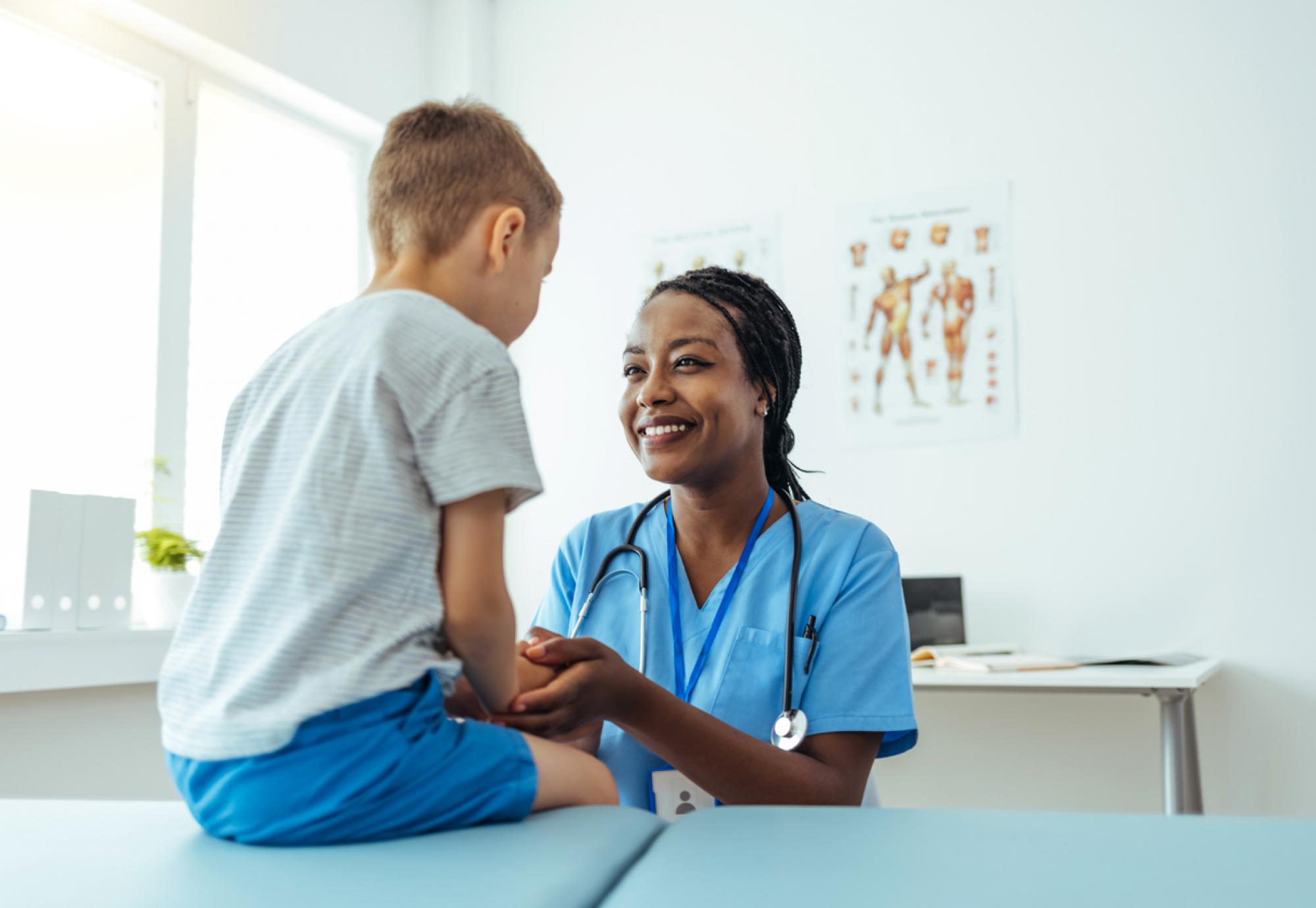 Image of health professional with a child depicting the NHS's new paediatric early warning system