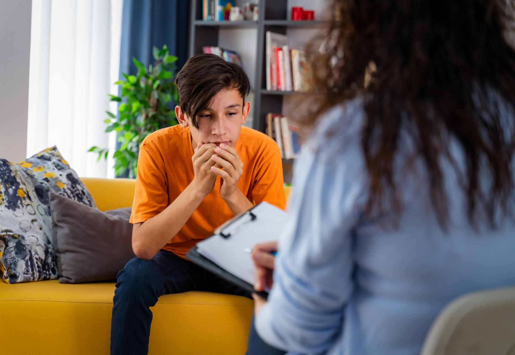 Psychologist with young boy in an office