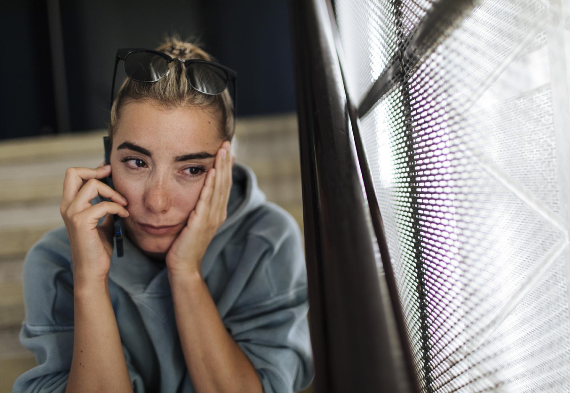 Young woman crying on the phone