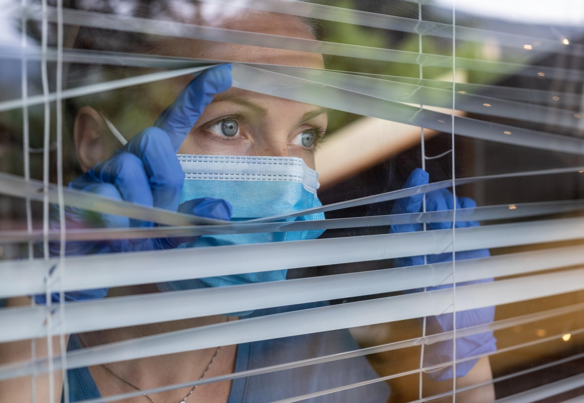 Medical Worker Behind Blinds