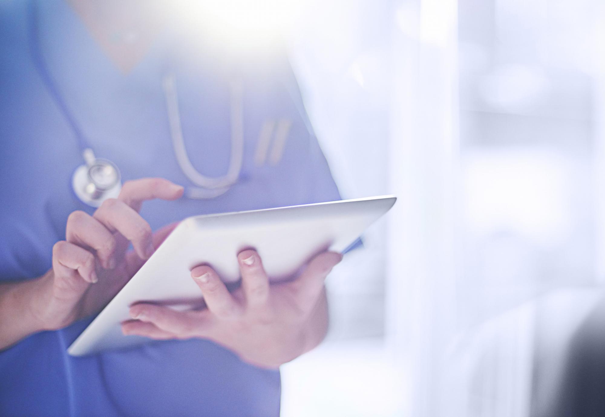 NHS doctor using a tablet