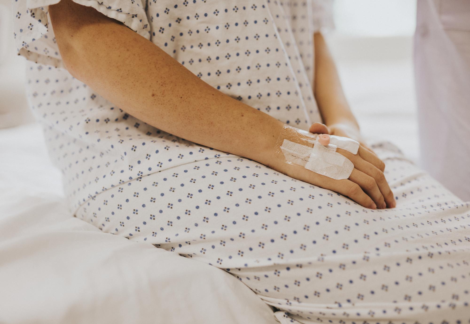 Woman sitting on her hospital bed