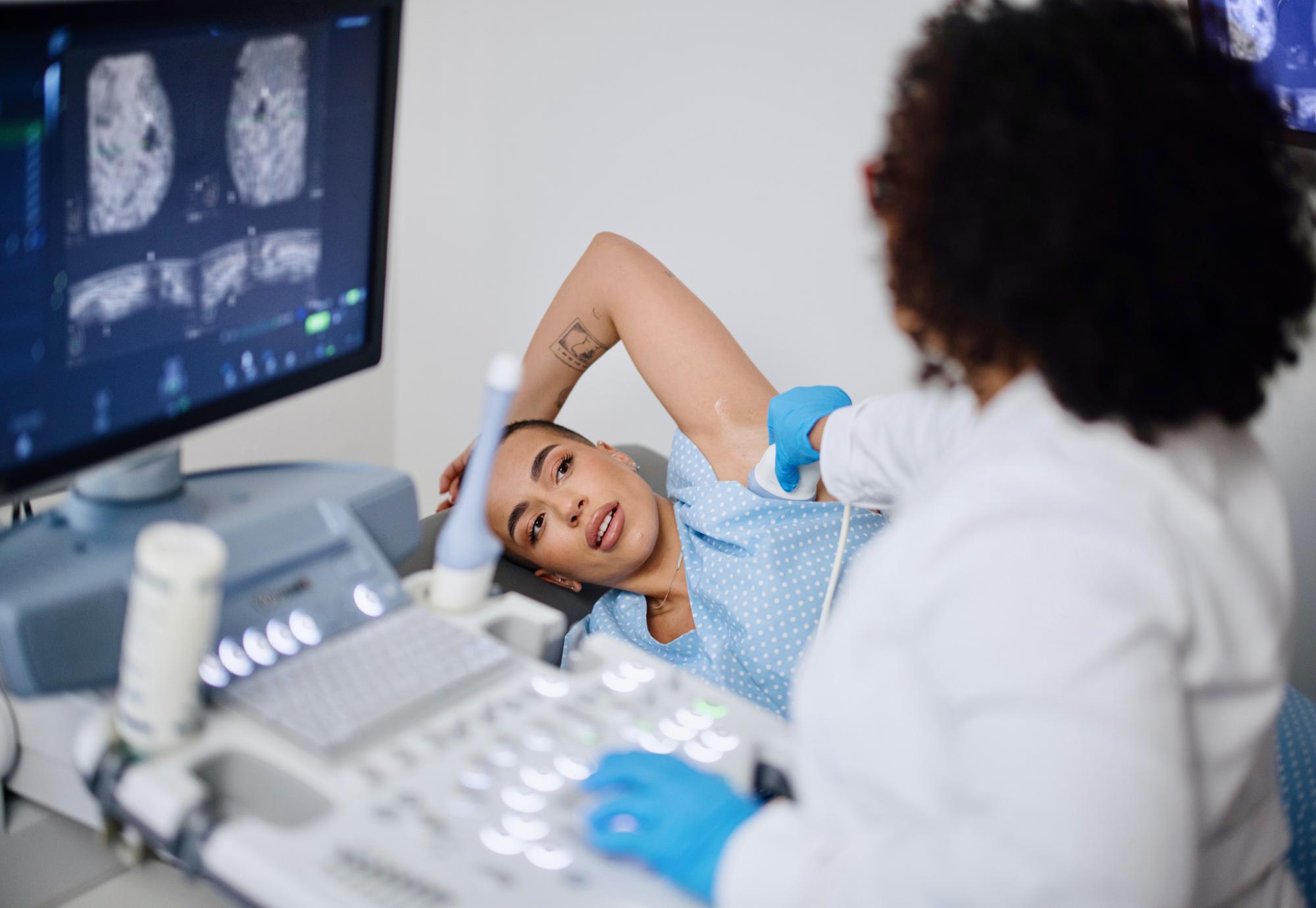 A young woman is doing a breast ultrasound for preventive breast cancer care