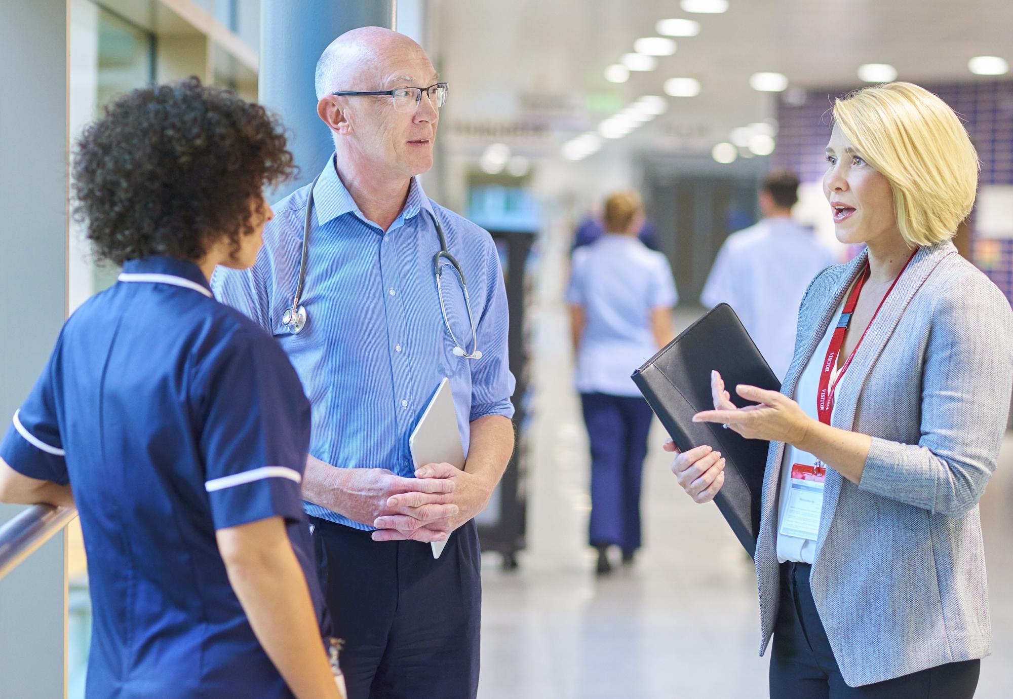 NHS professionals talking in a corridor