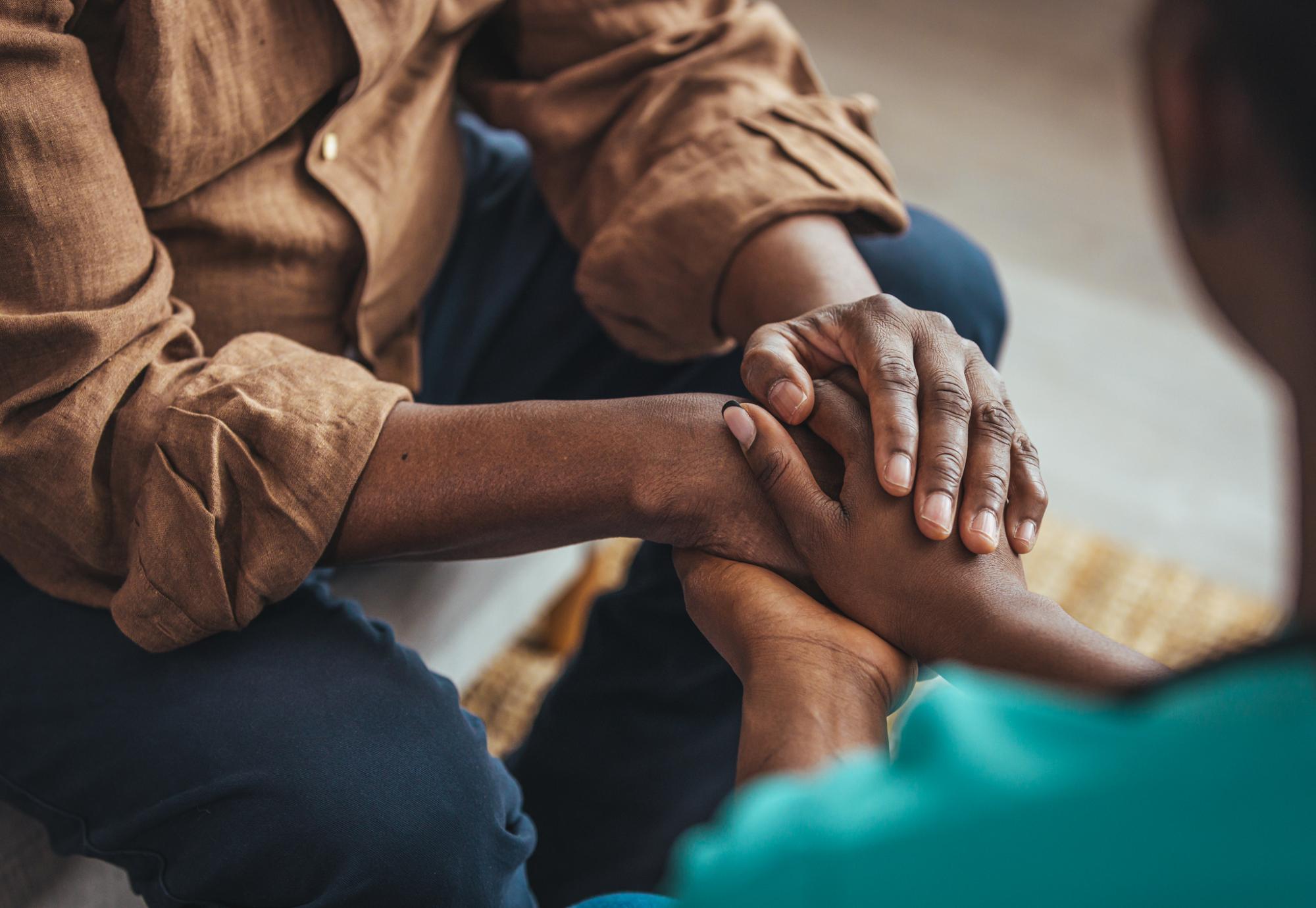 Two people holding hands