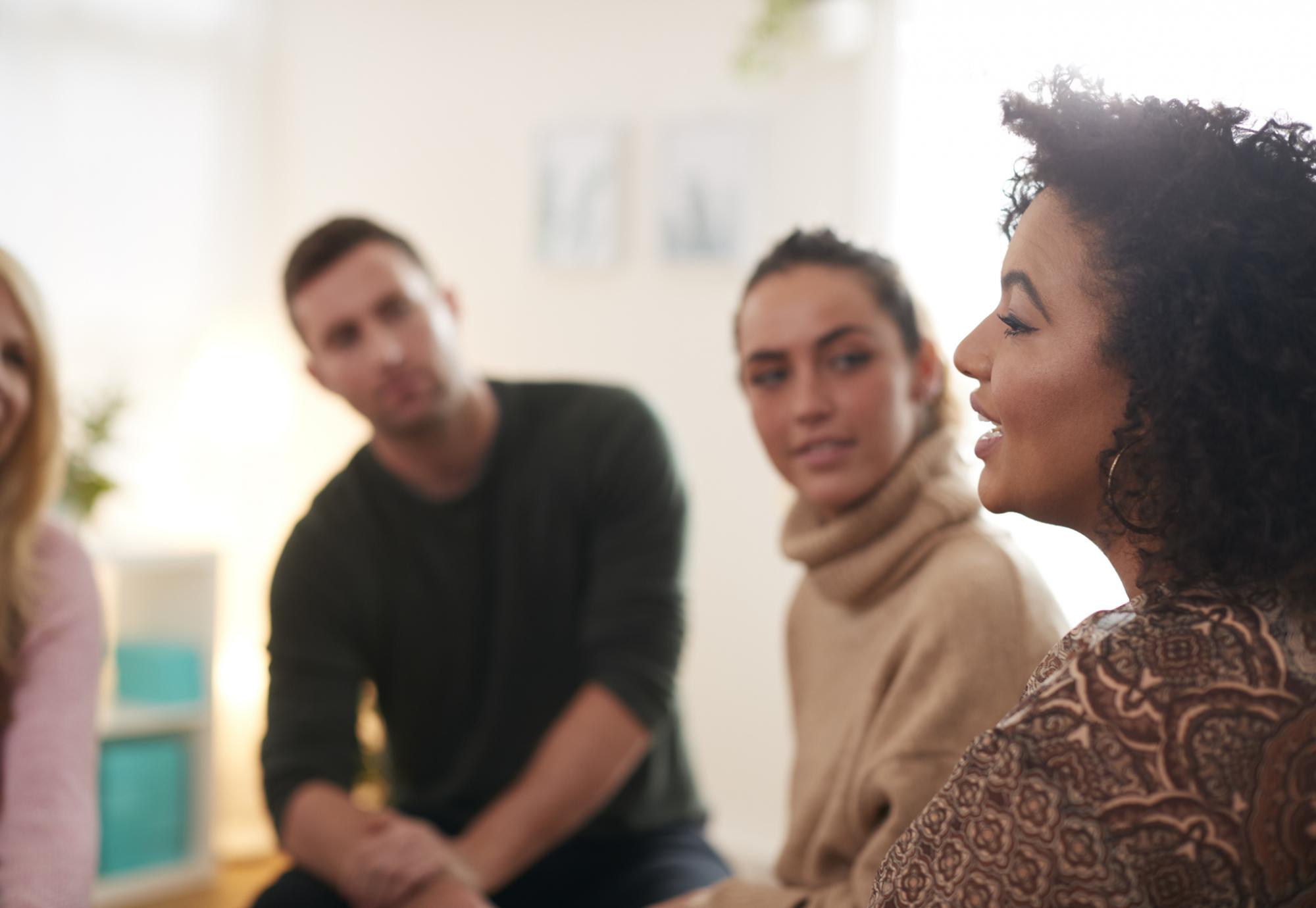 Woman Speaking At Support Group Meeting For Mental Health