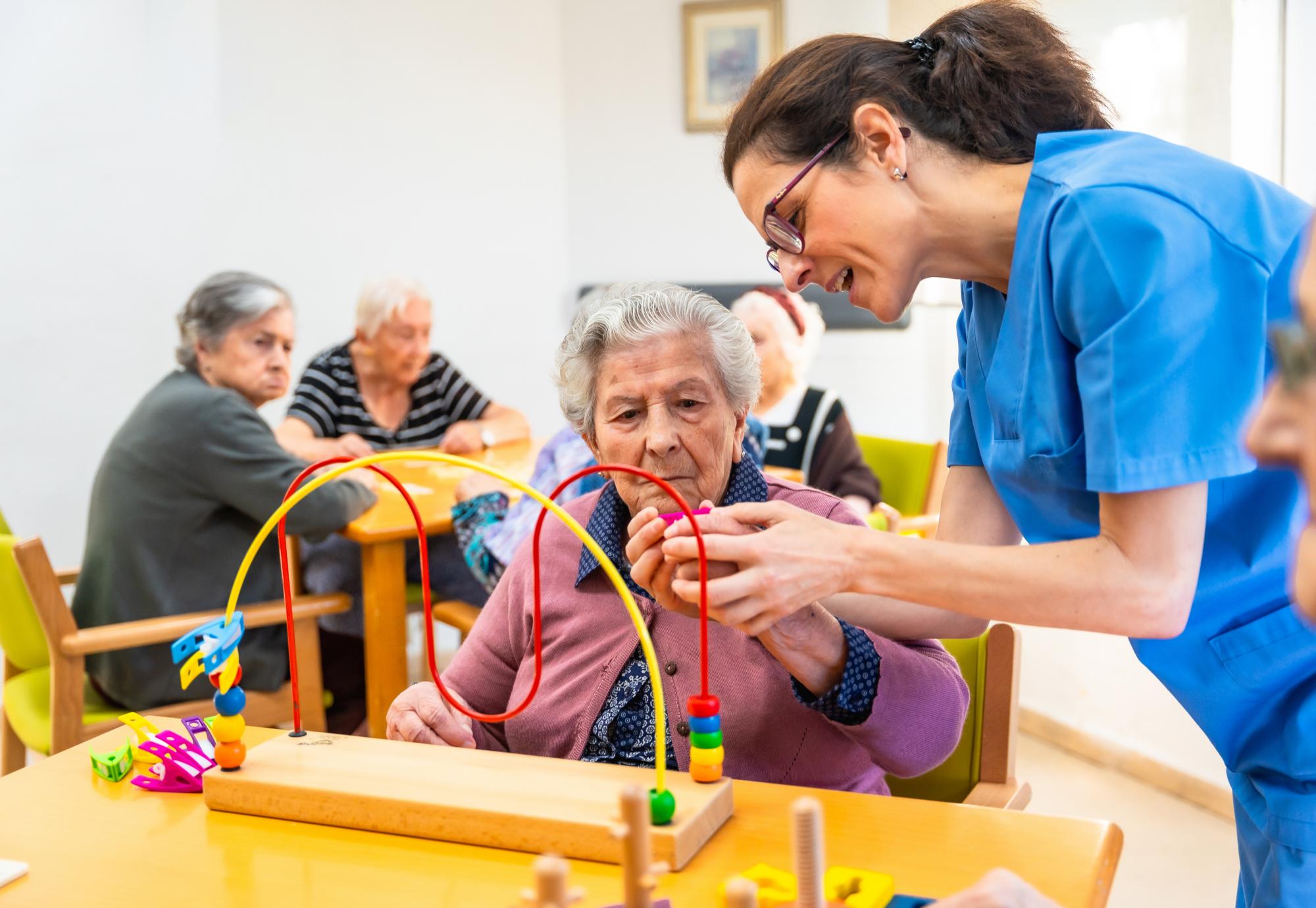 Occupational therapist supporting a patient with a neurological condition