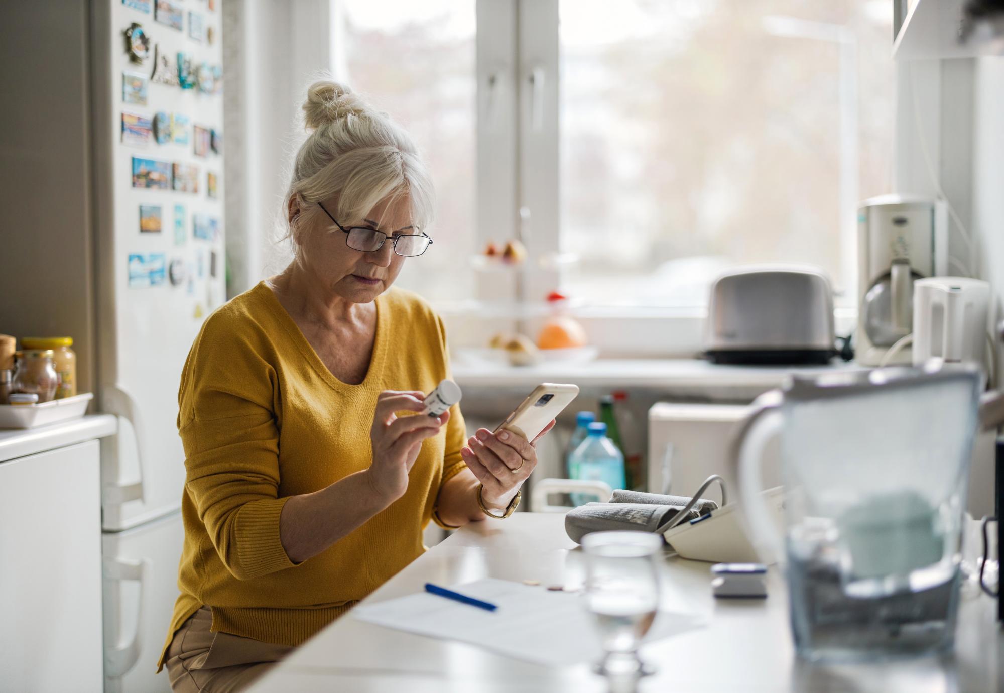 Older woman on medication with mobile phone