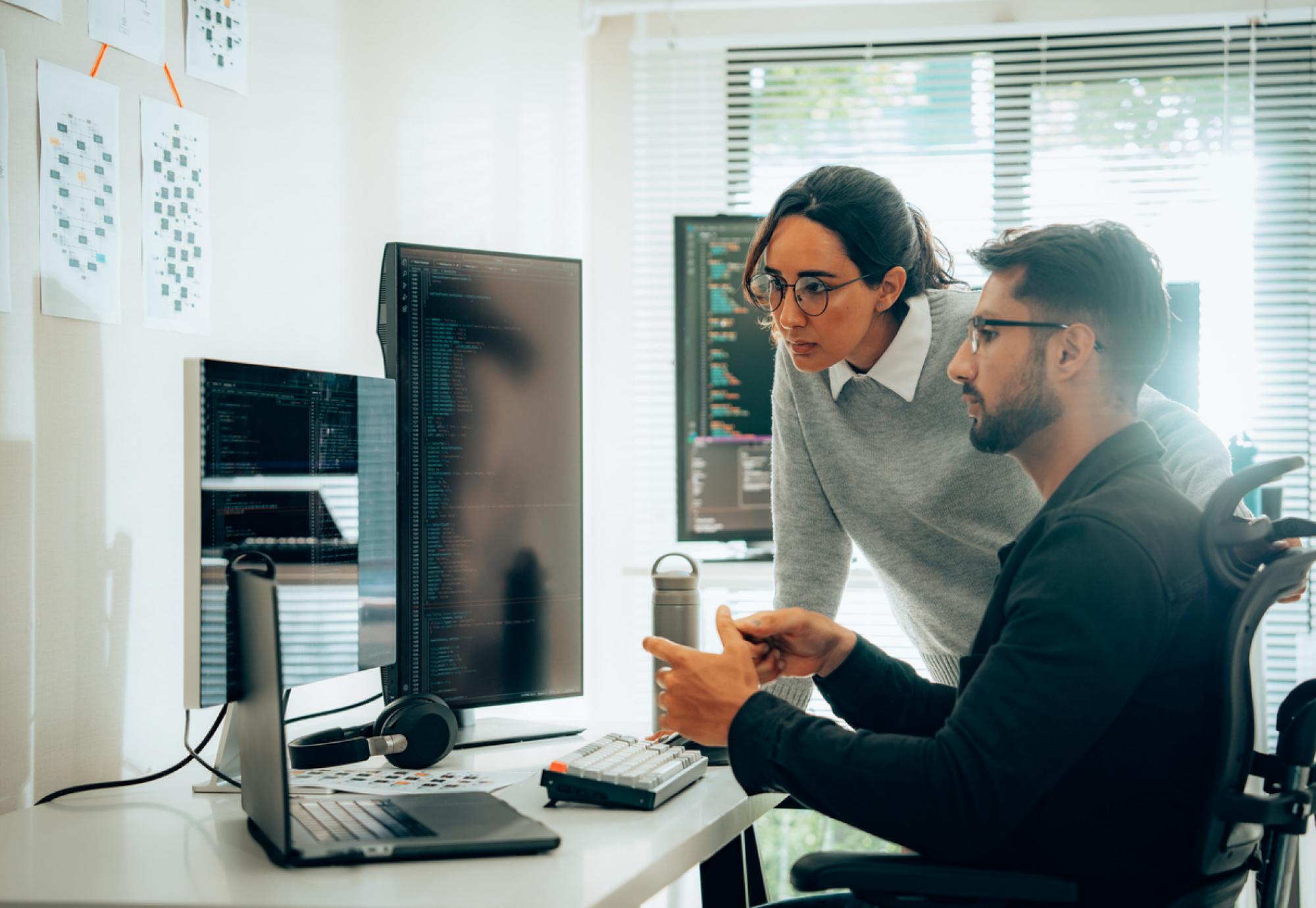 Two people looking at AI research