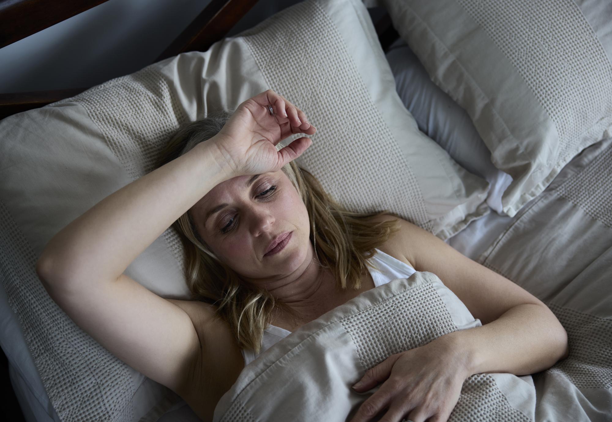 Woman in pain in bed