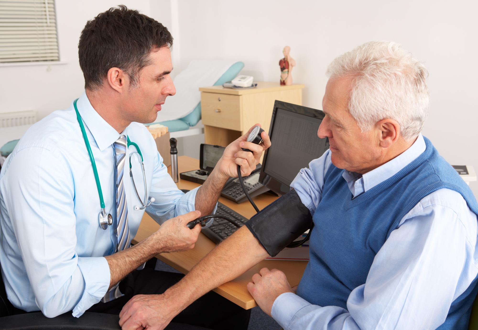 Doctor taking a man's blood pressure