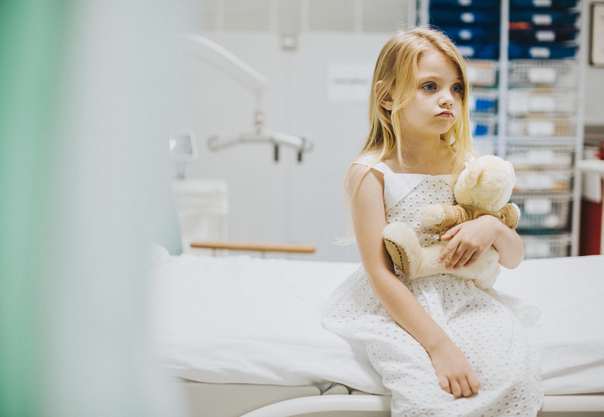 Child sitting on a hospital bed