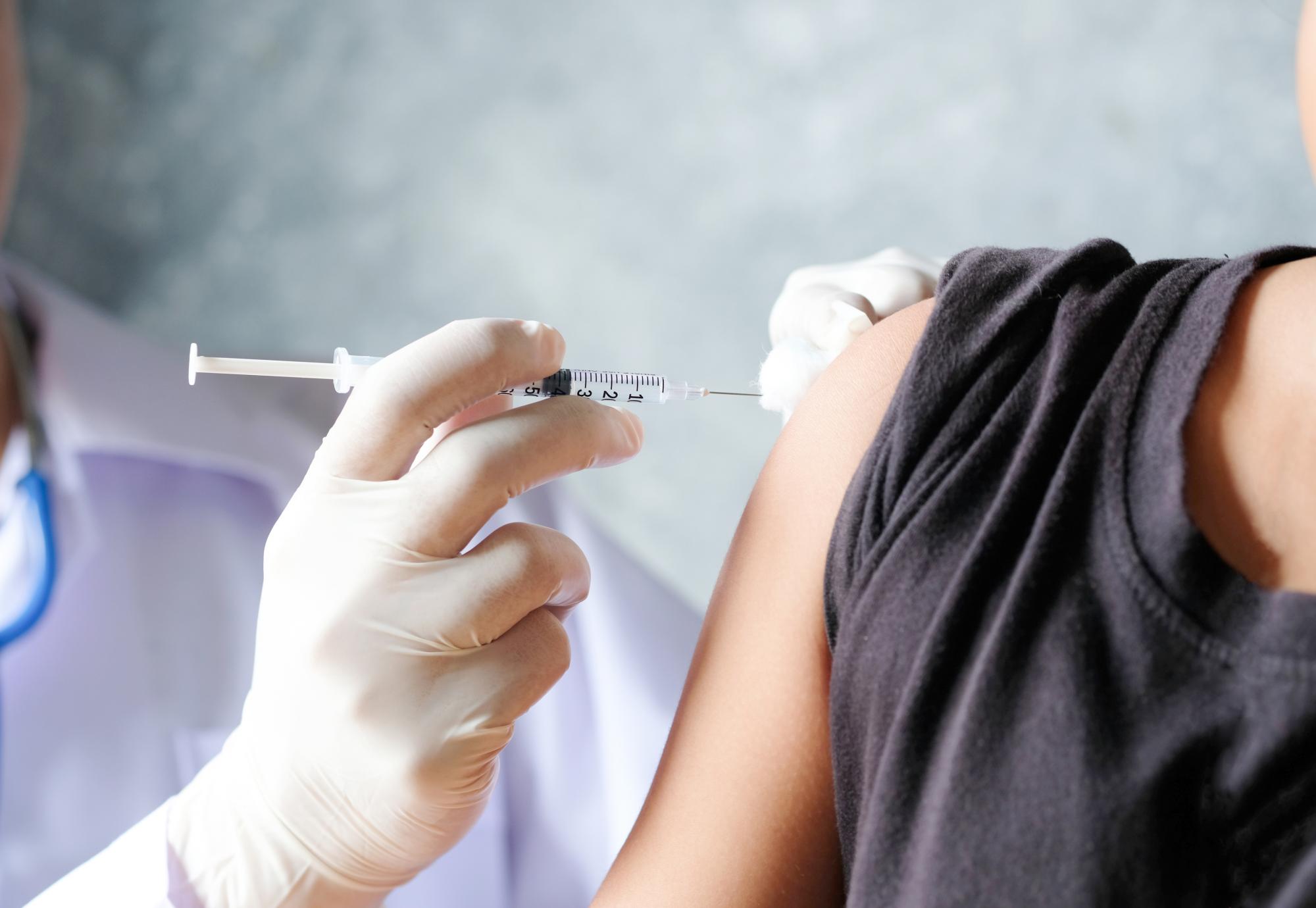 Doctor injecting a patient with a vaccine
