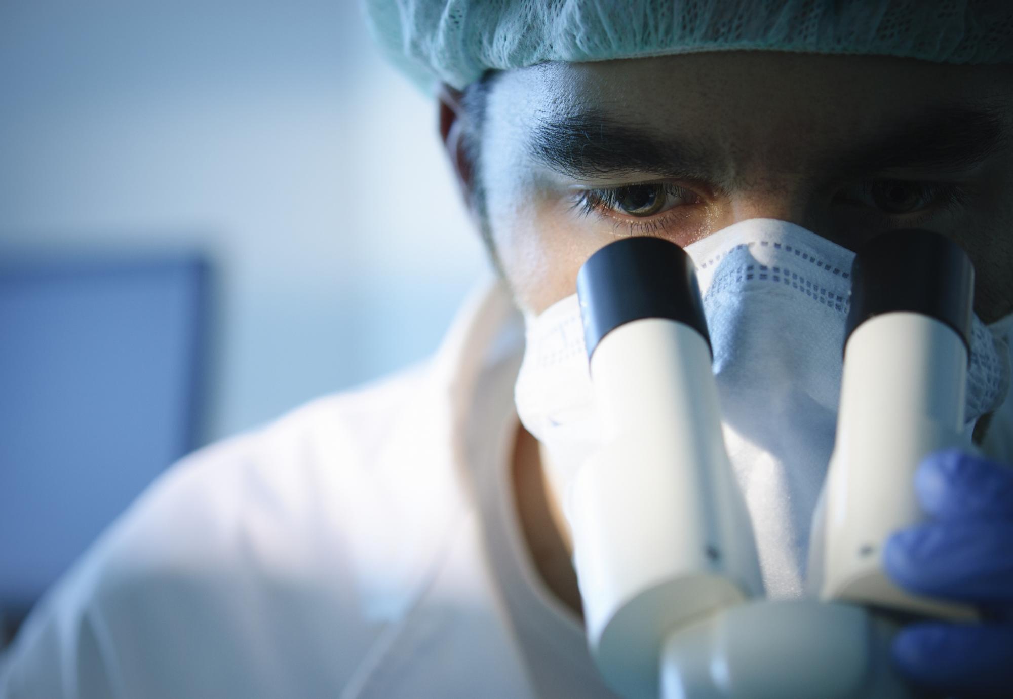 Scientist using a microscope