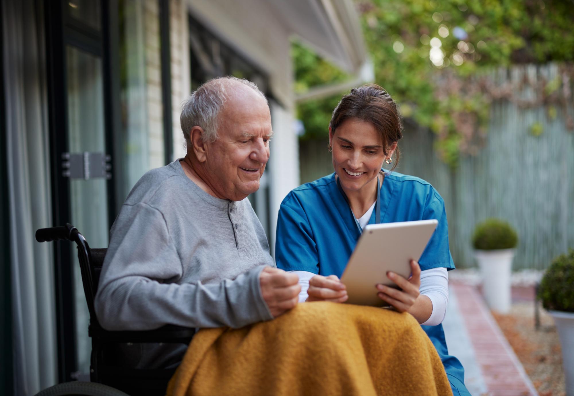 Nurse giving care at home to an elderly man