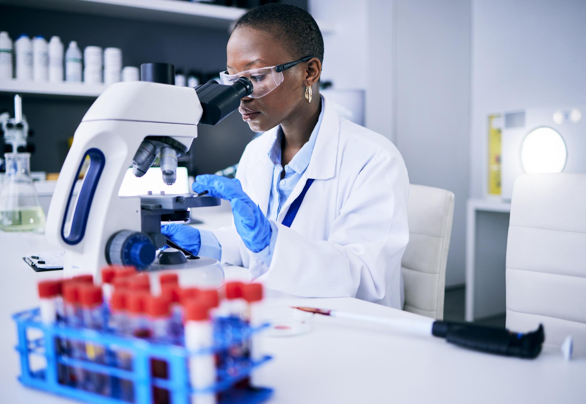 Scientist looking into a microscope