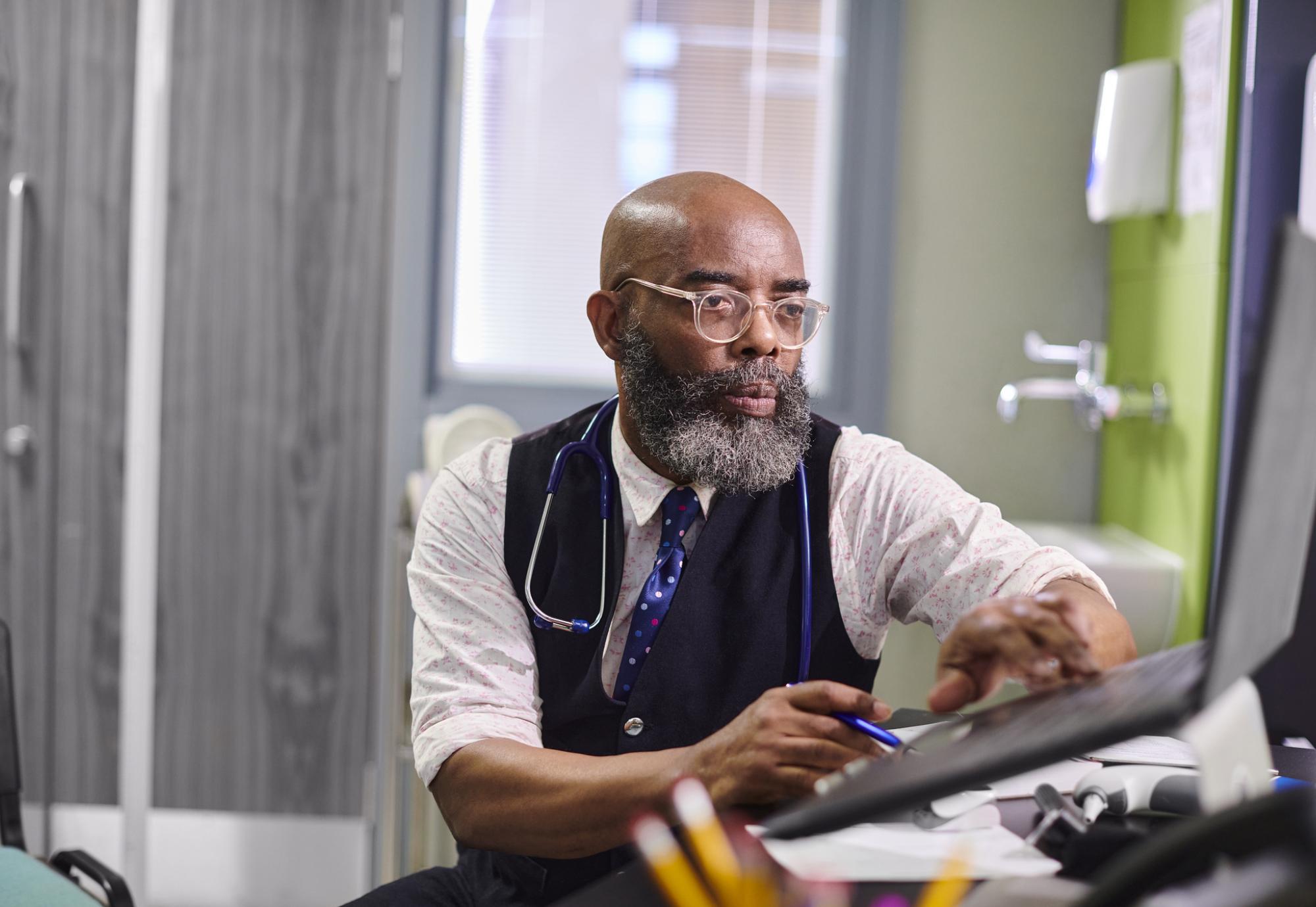 male gp working on a computer