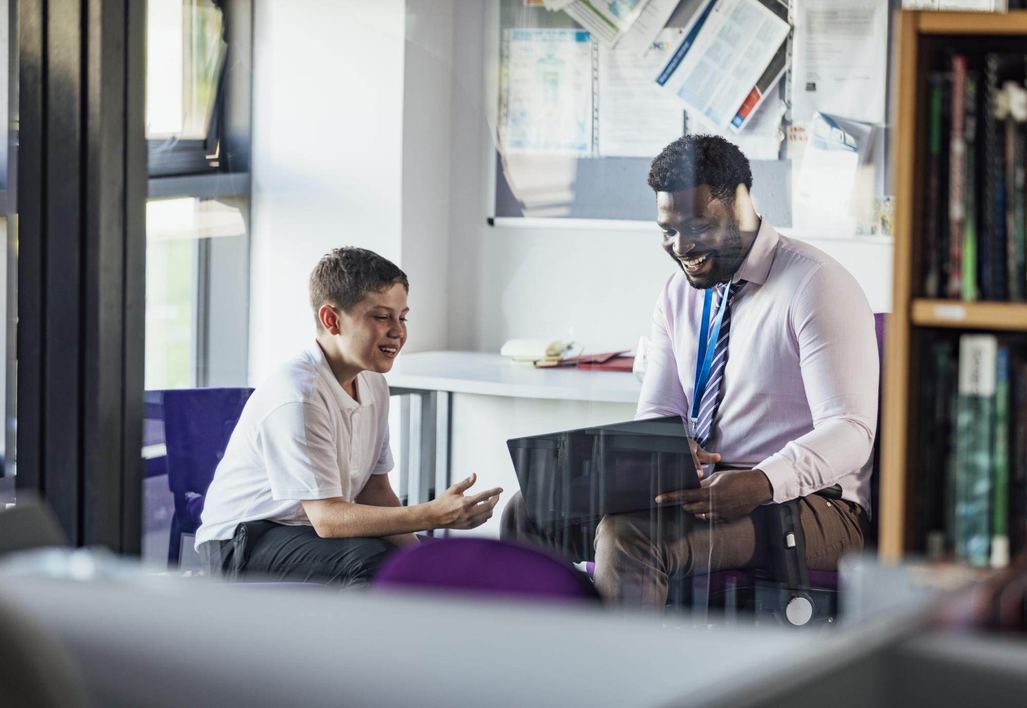 Teacher sat with a pupil