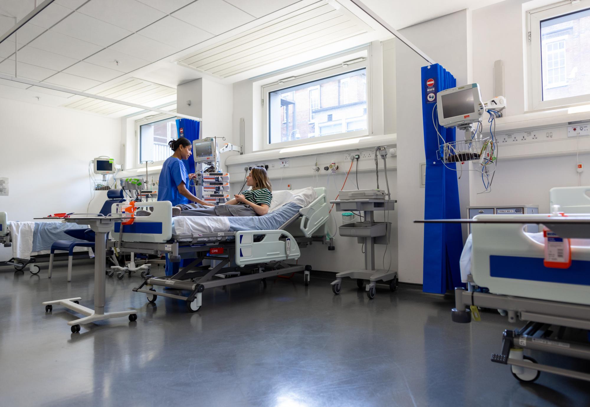 Woman in hospital talking to a nurse