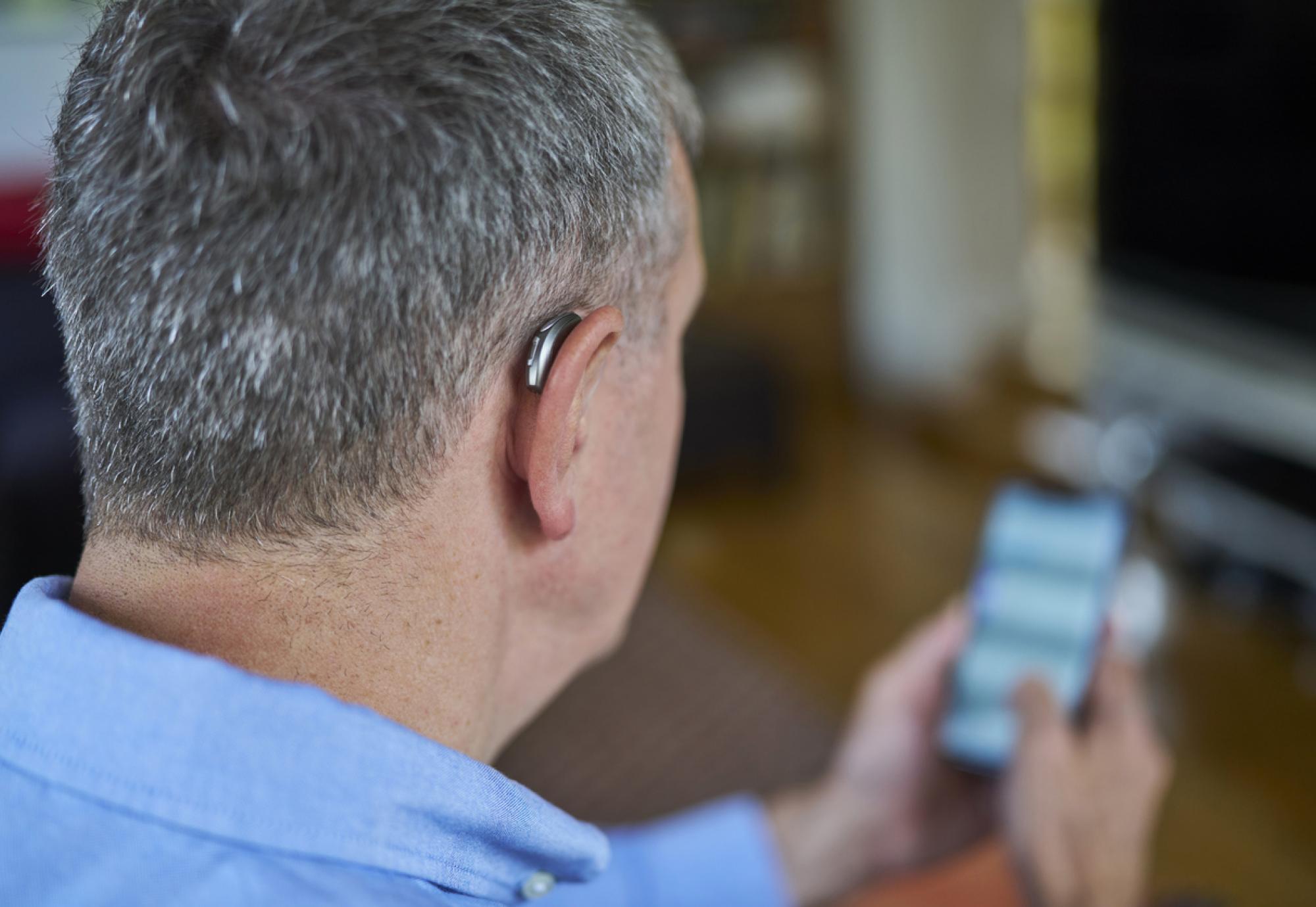 Man Wearing Wireless Hearing Aid