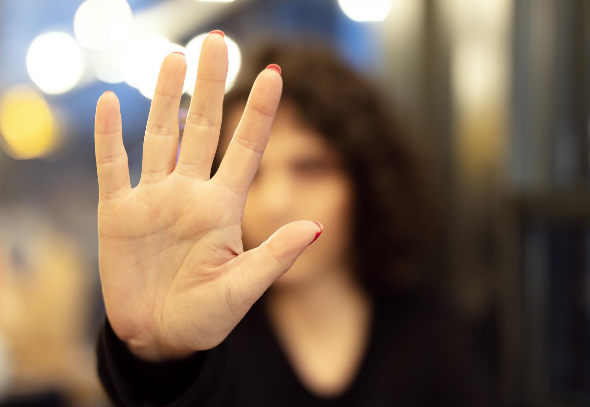 Woman holding her hand up