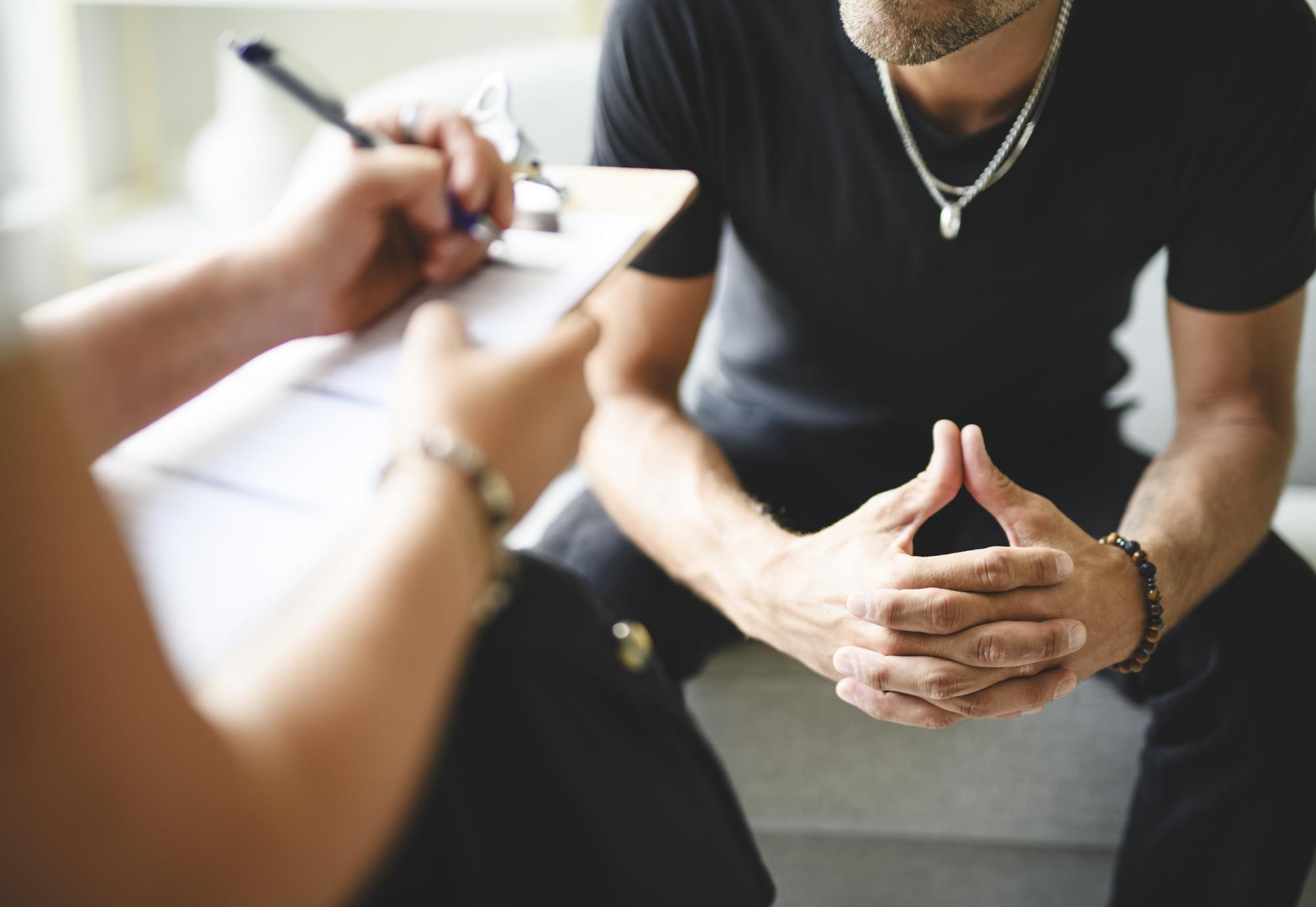 Man being supported with addiction