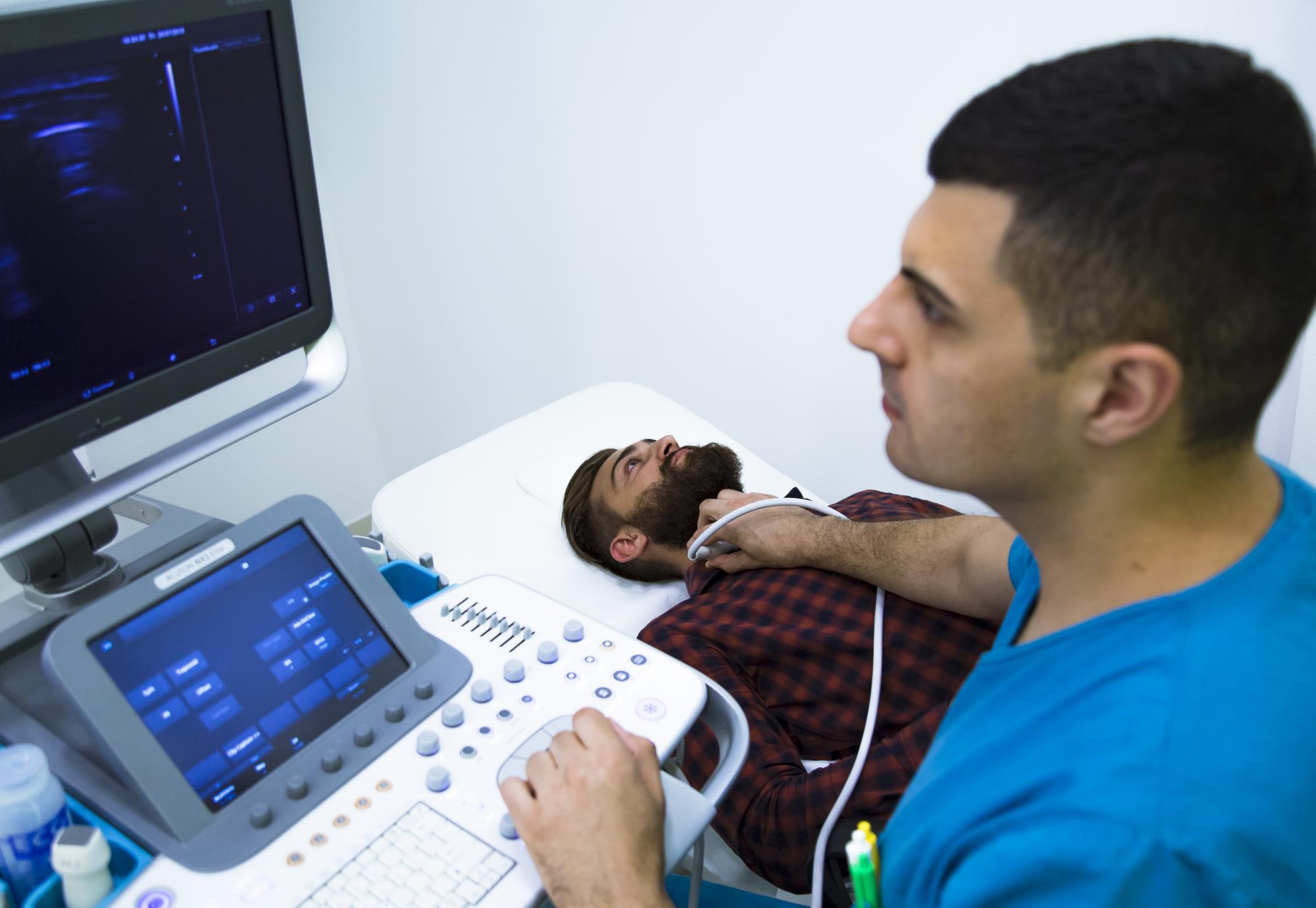 Man having his thyroid scanned