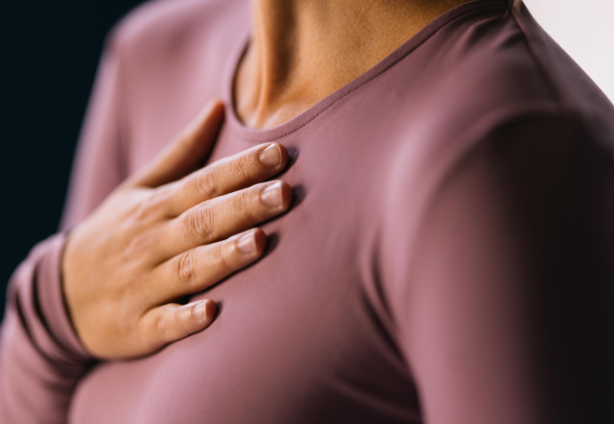 Woman with a hand on her chest
