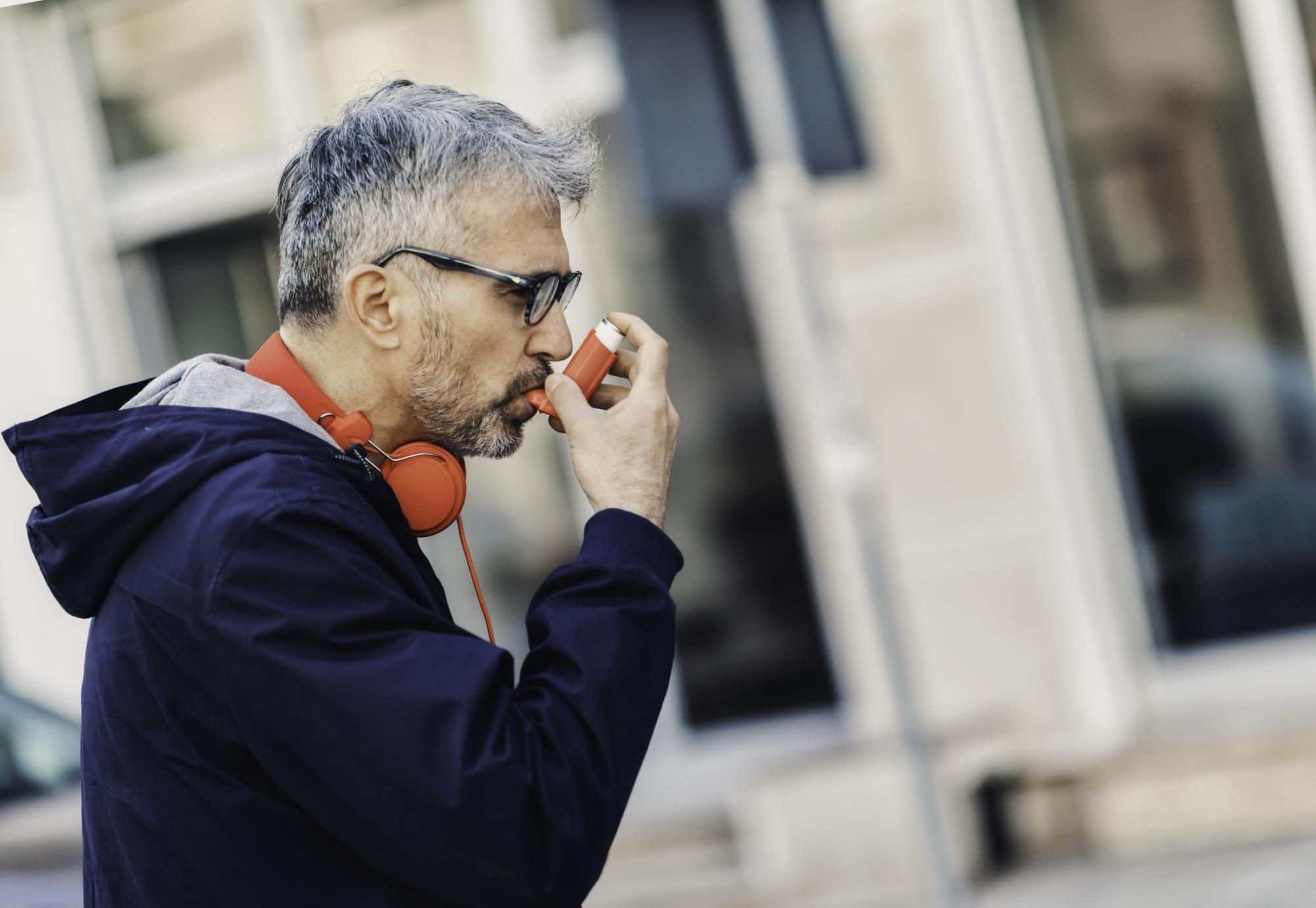 Man using an inhaler