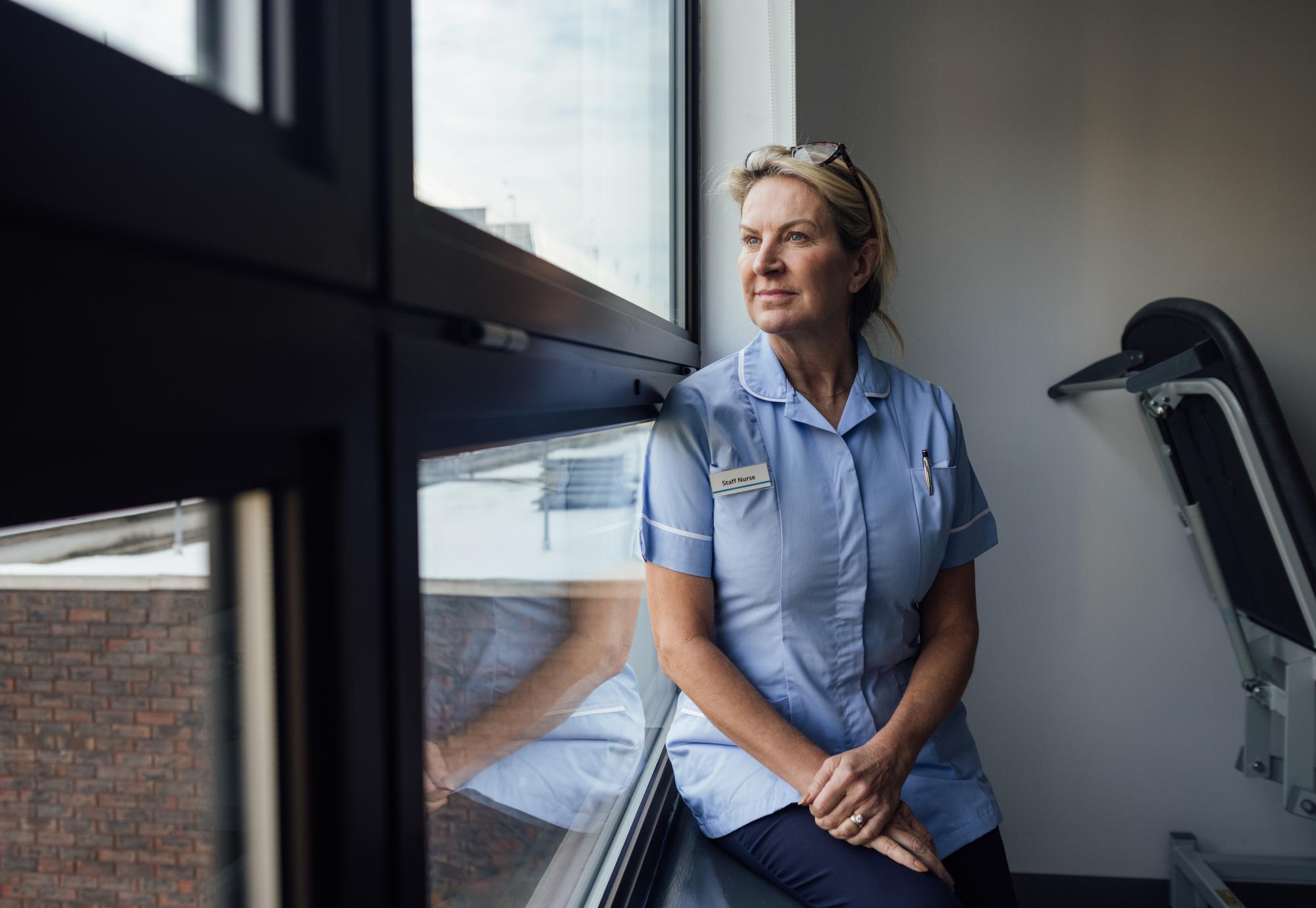 Nurse looking out of a window