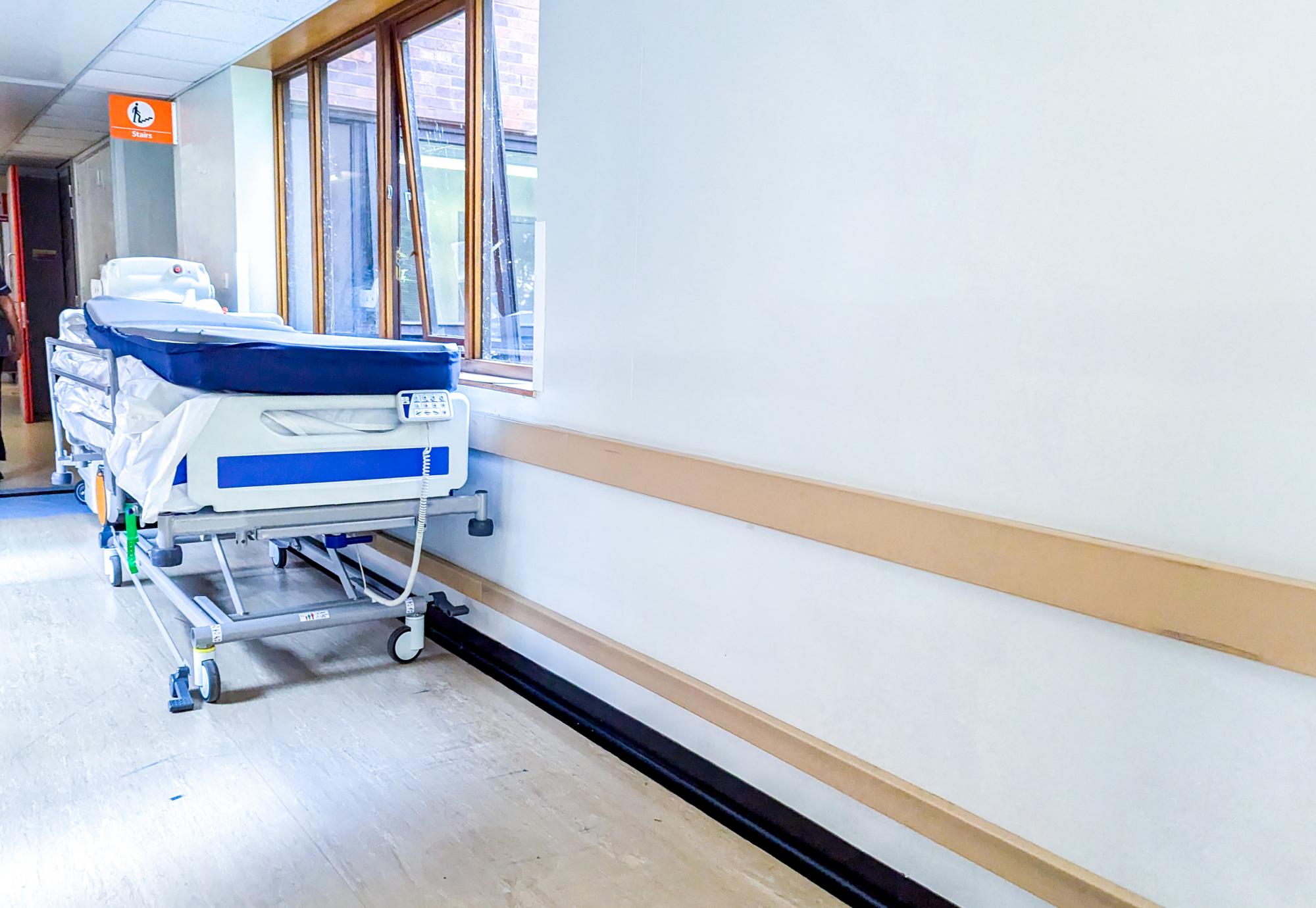 Bed in hospital corridor