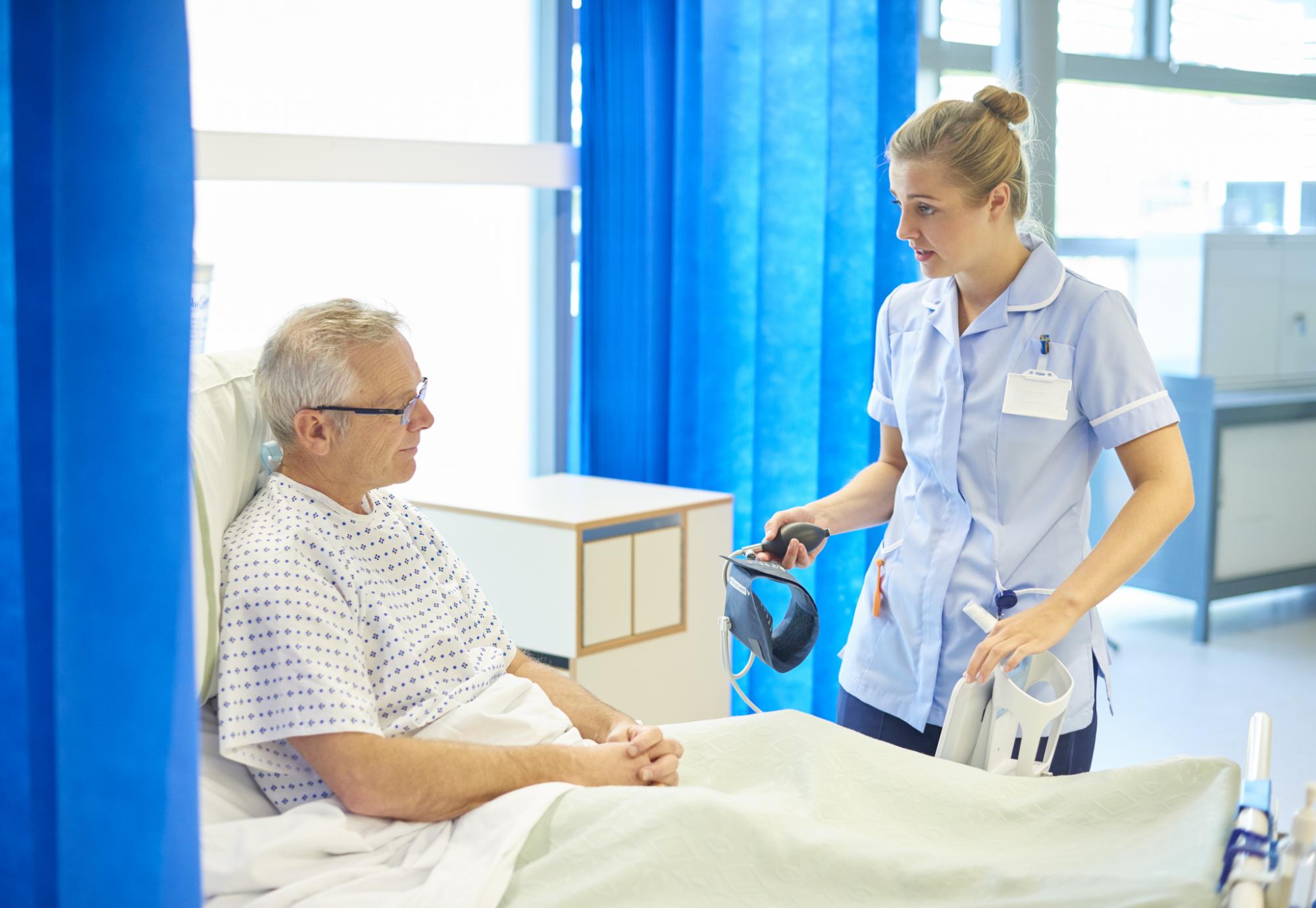 Nurse talking to a older male patient