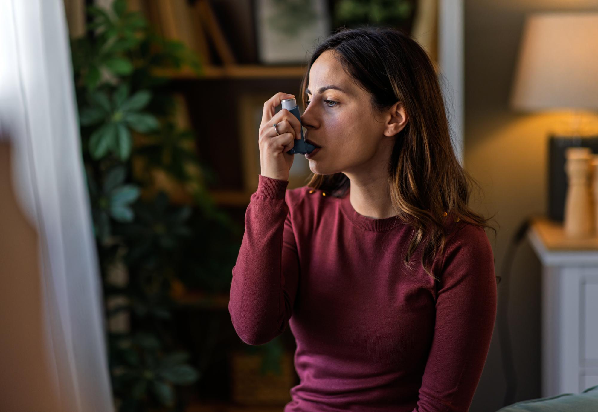 Woman using an inhaler
