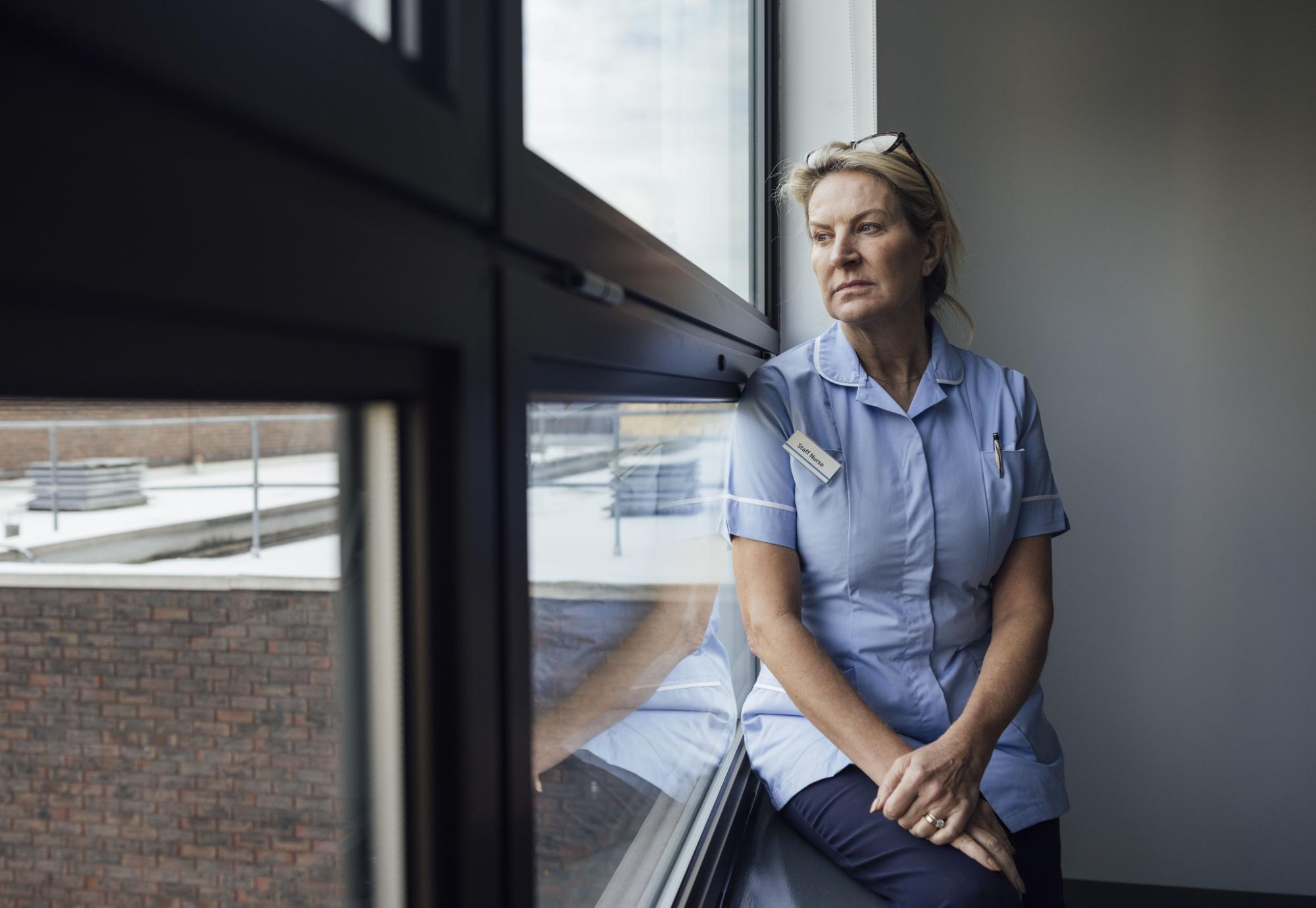 Nurse sat by a window