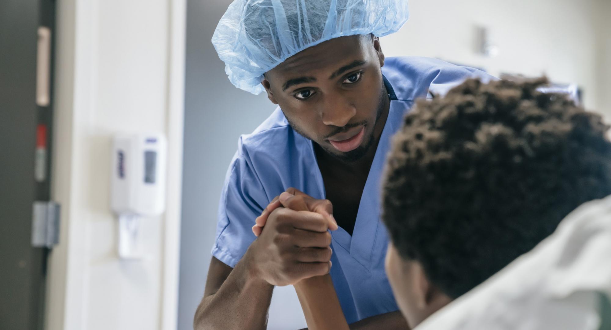 Male nurse attending to patient