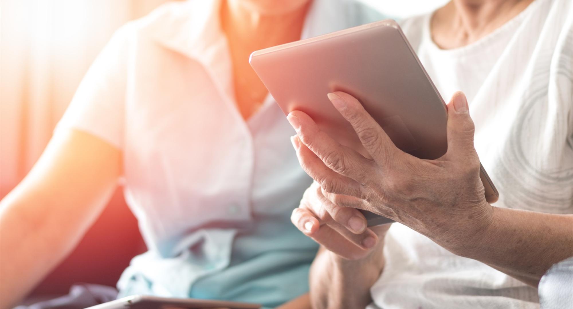 Two people using a tablet PC