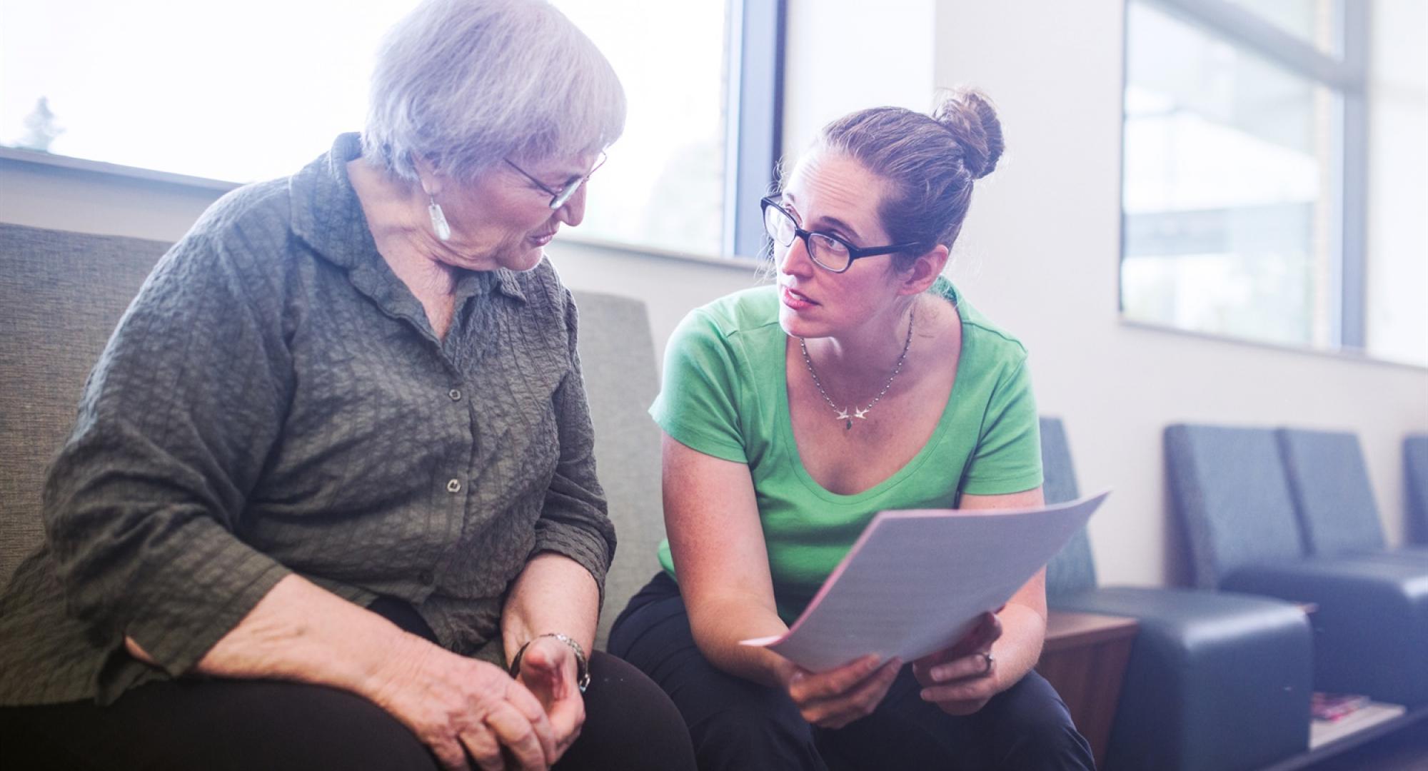 Woman supporting elderly patient