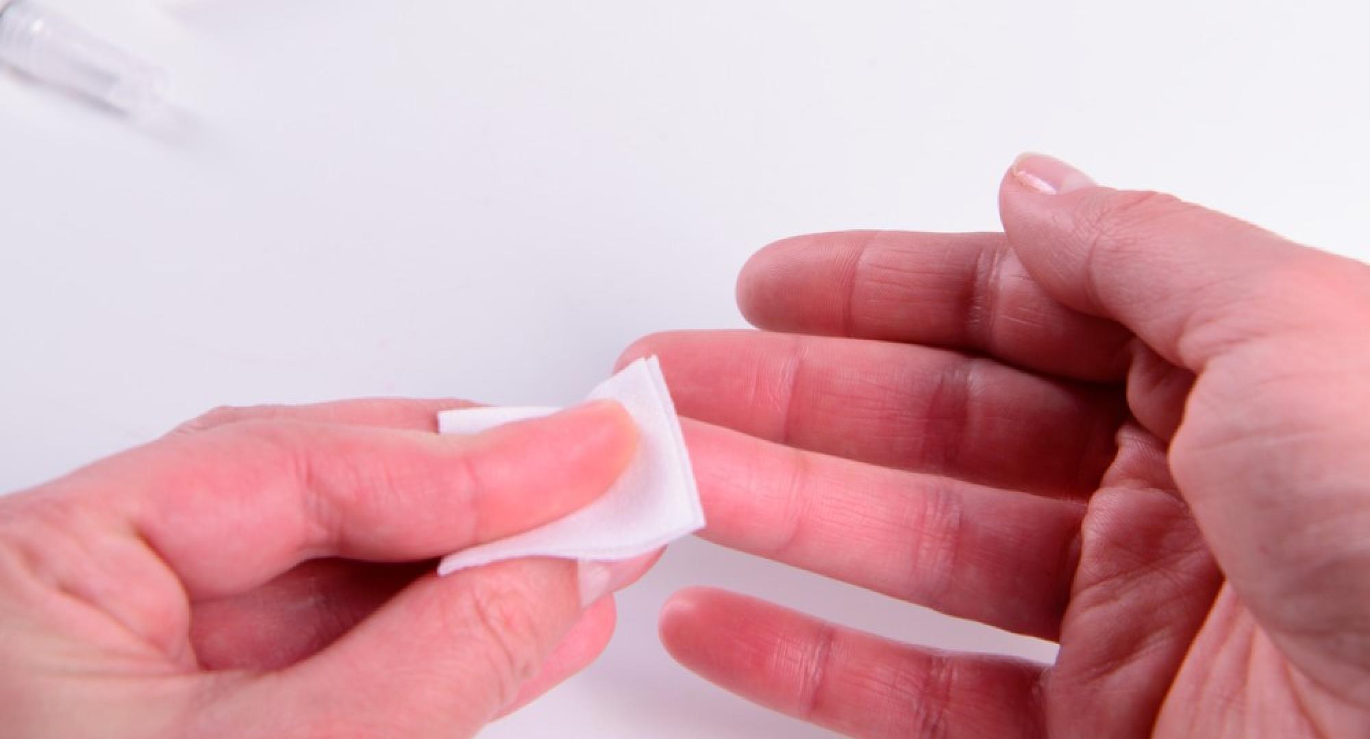 A person holding tissue on their finger 