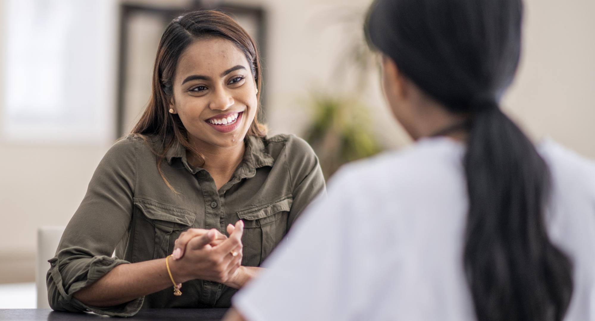 Woman having conversation with mental health professional