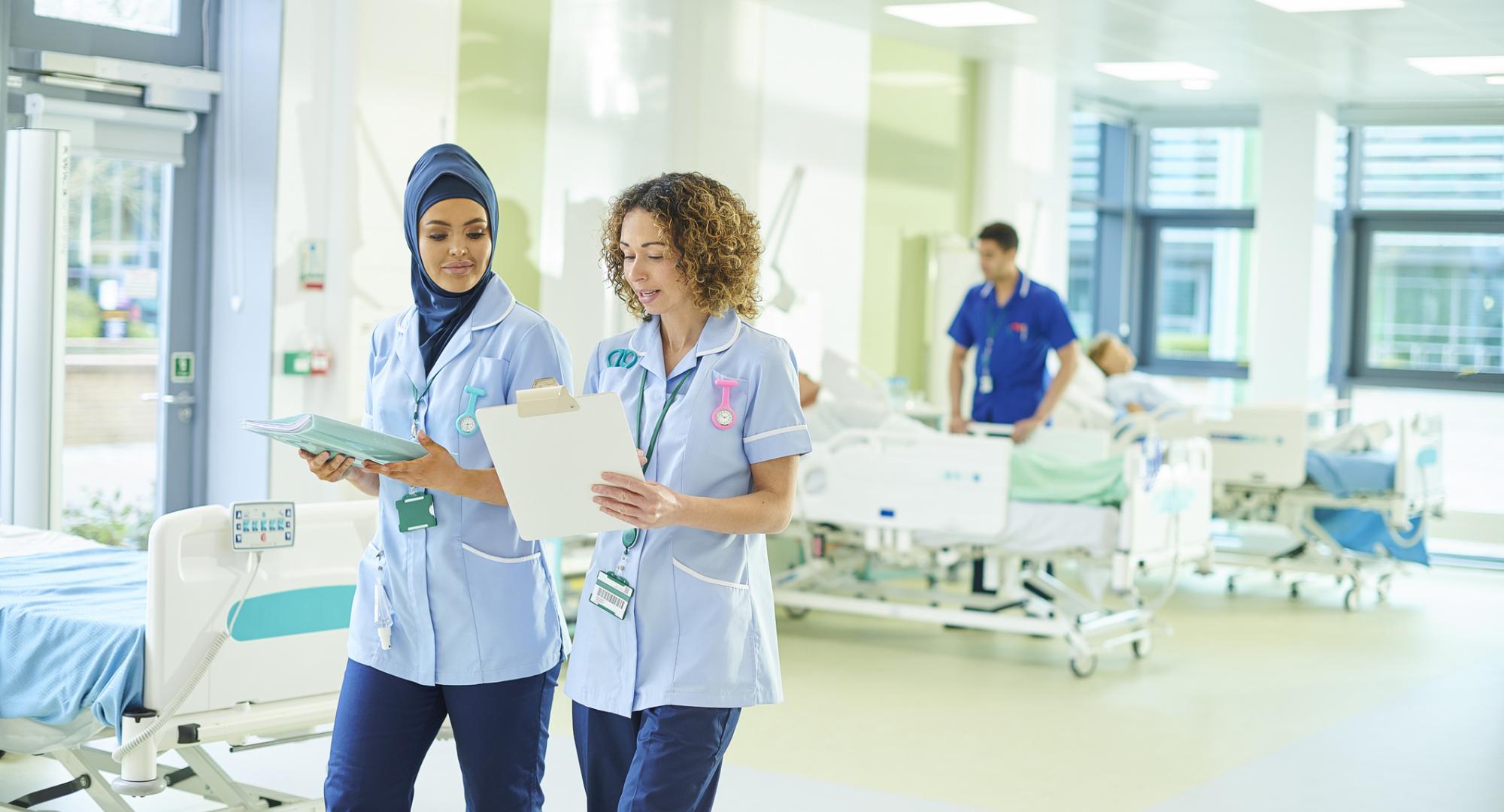 Female health professionals discussing during a ward round