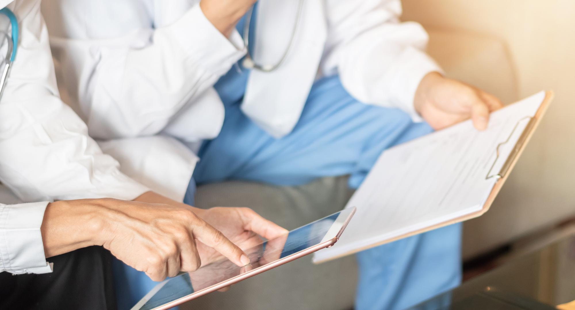 Two medical professionals looking at an iPad 