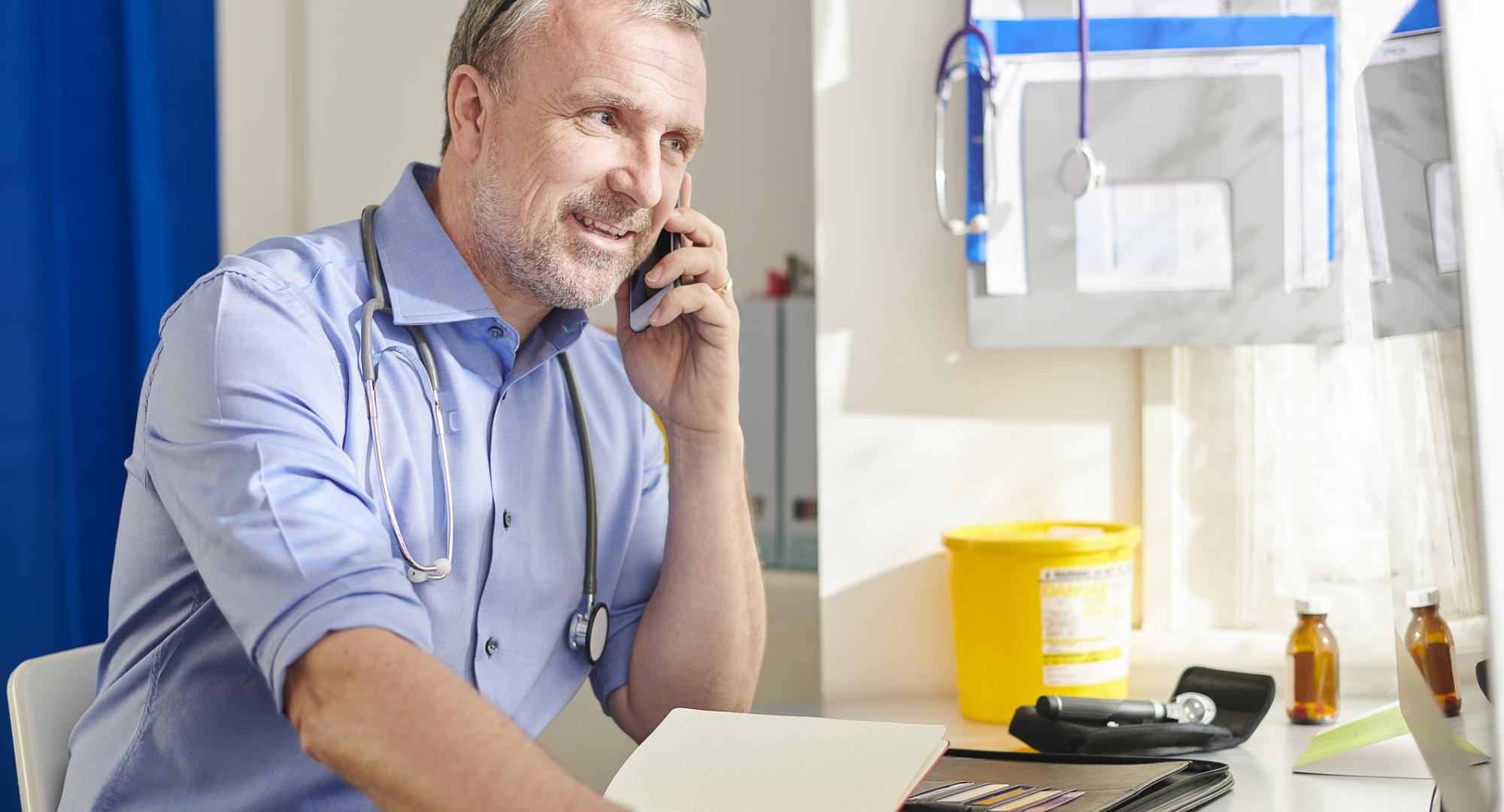 Consultant using the phone to speak with colleagues