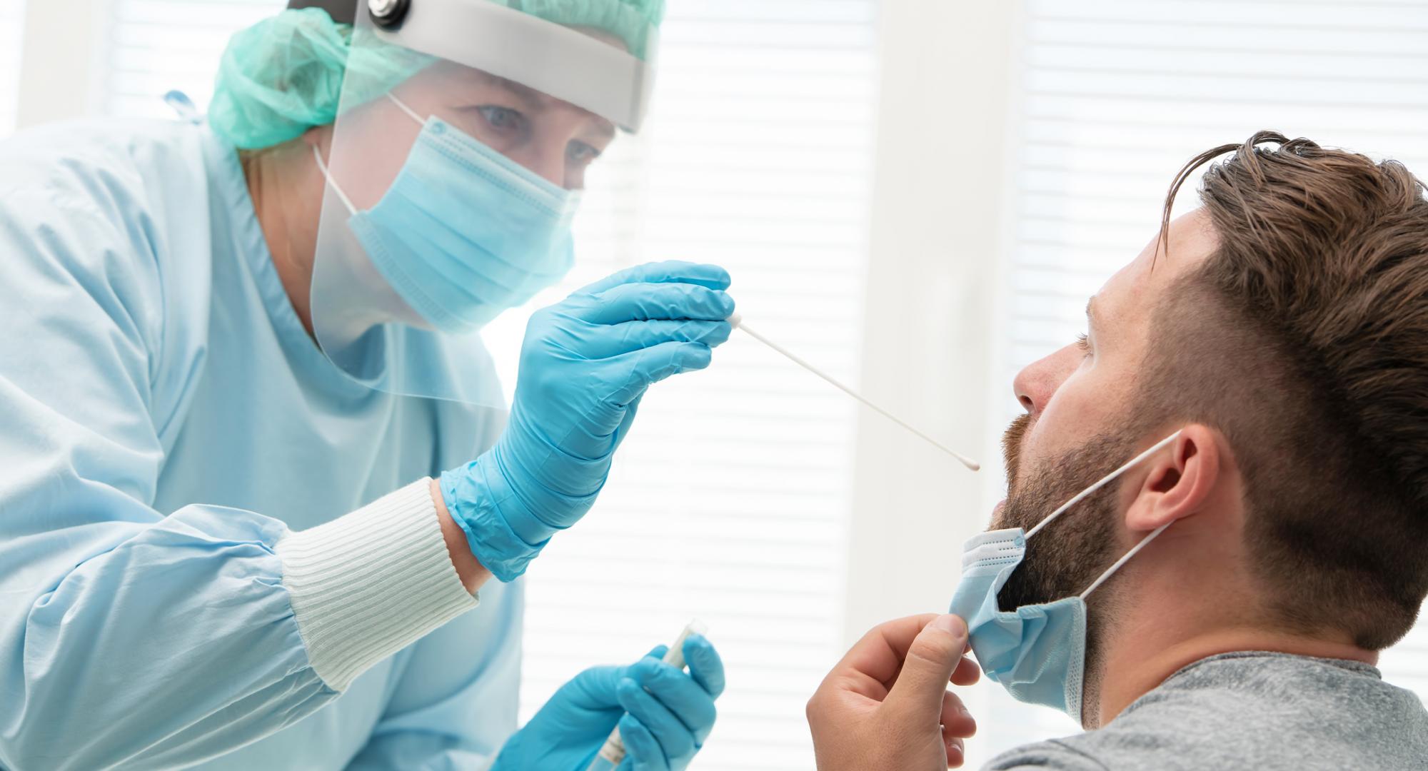 Health professional carrying out a nasal swab on a patient