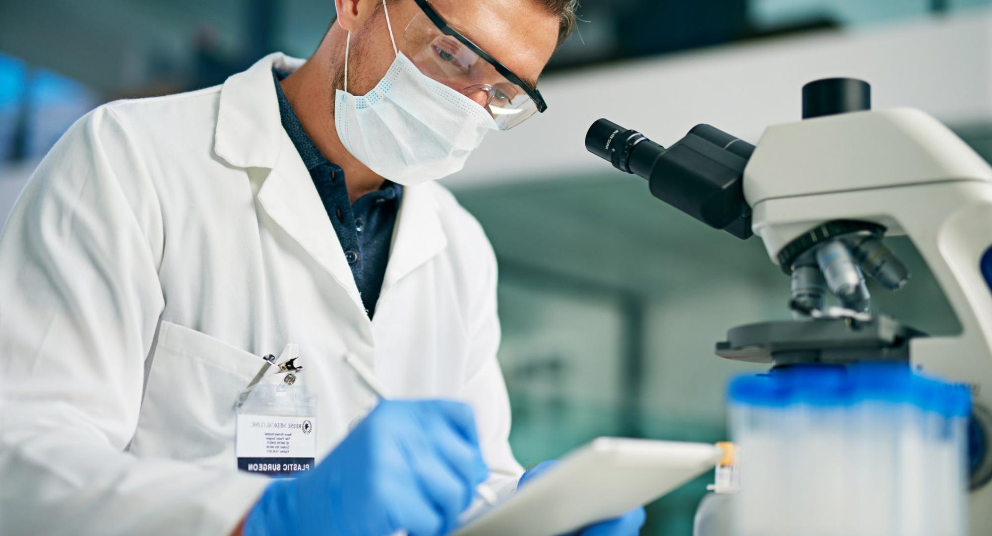 Scientist using a tablet computer in a lab setting