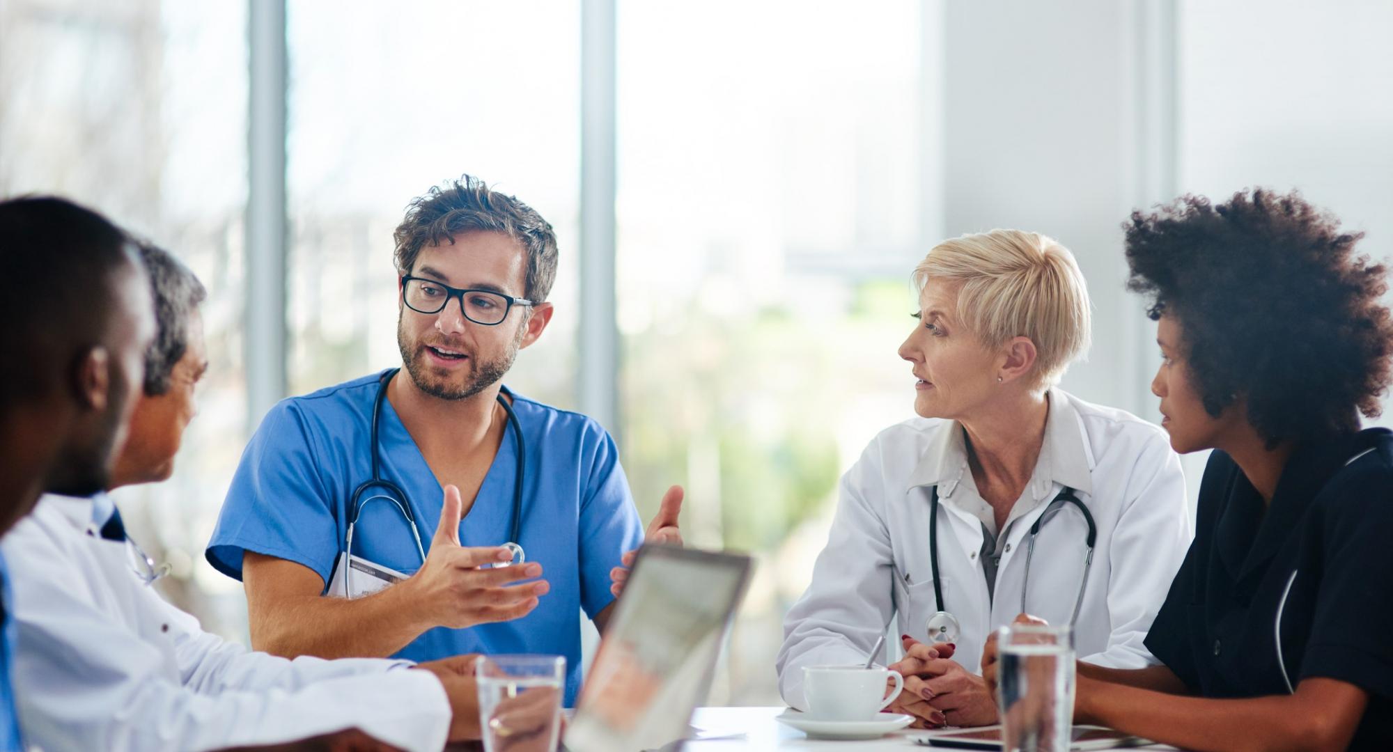 Doctors sat in a meeting discussing plans