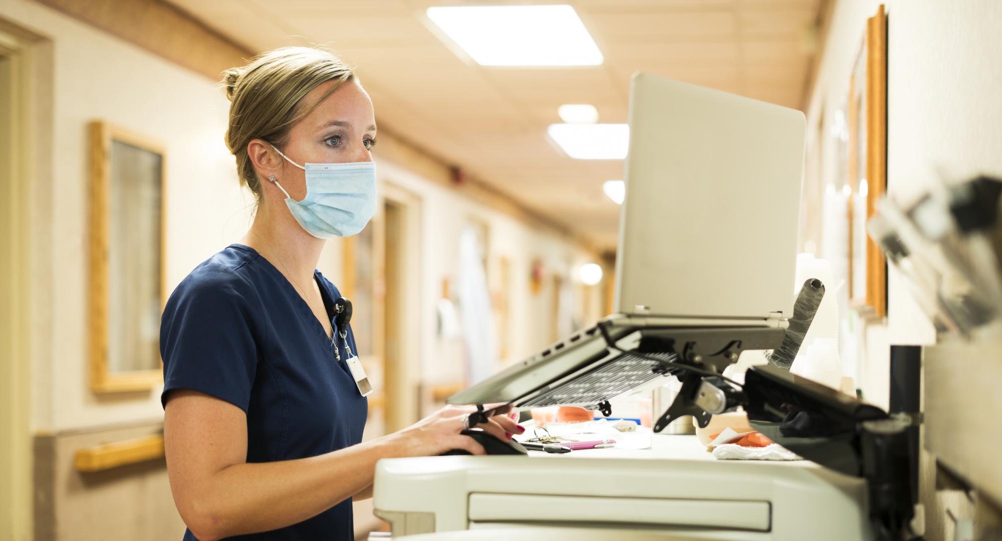 Nurse using a computer on a hospital ward