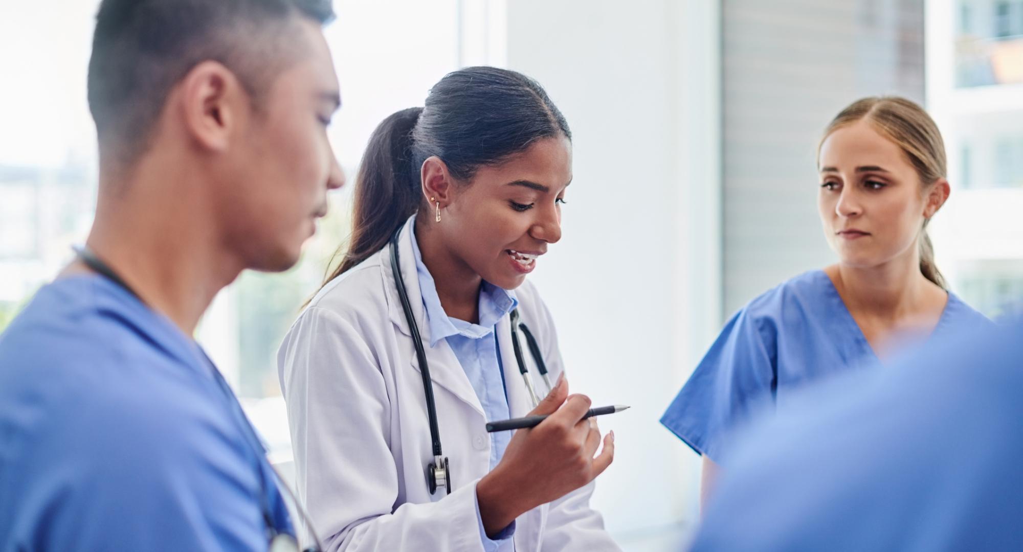 Doctors and nurses talking in a group