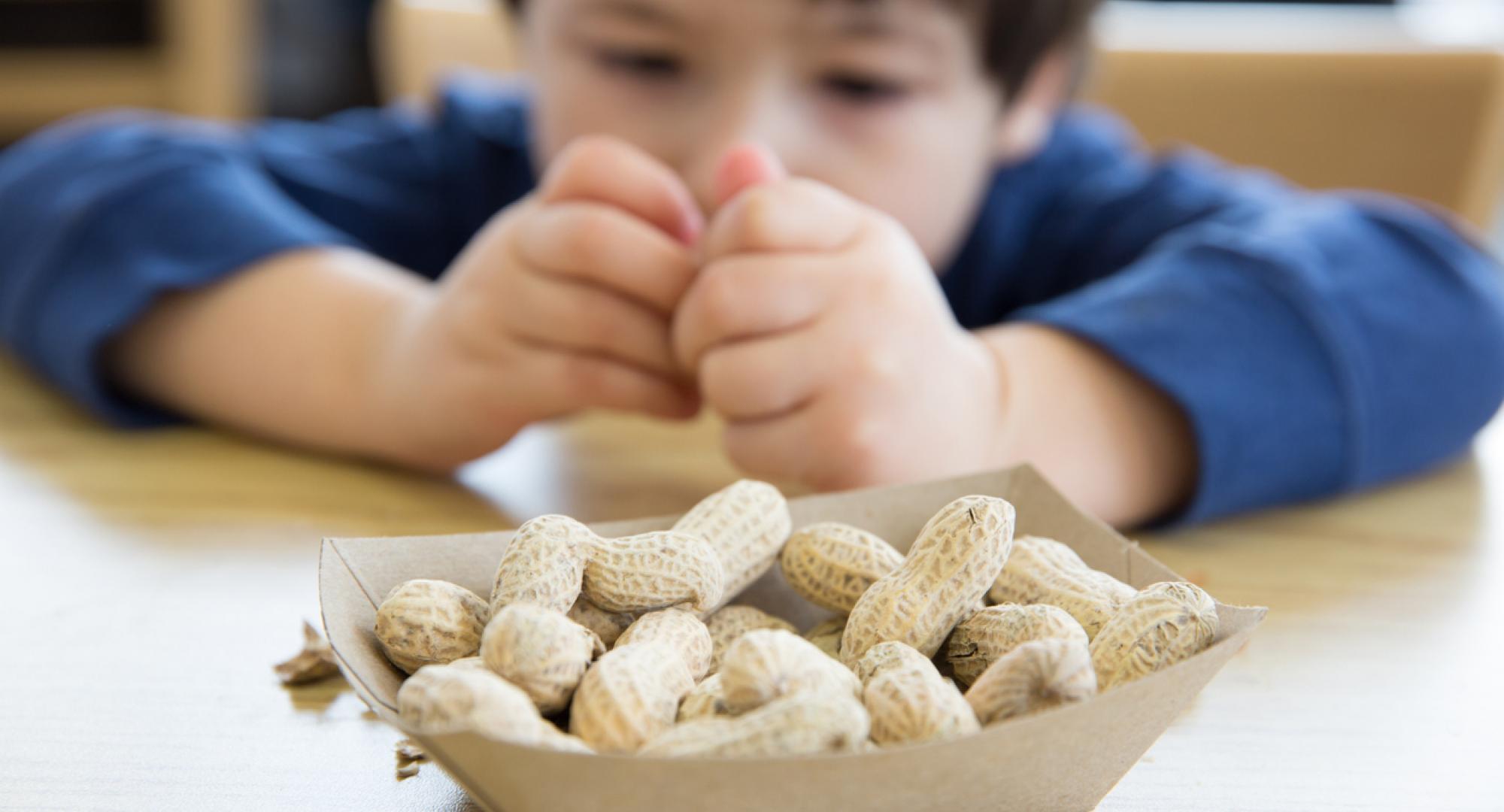 child holding peanut 
